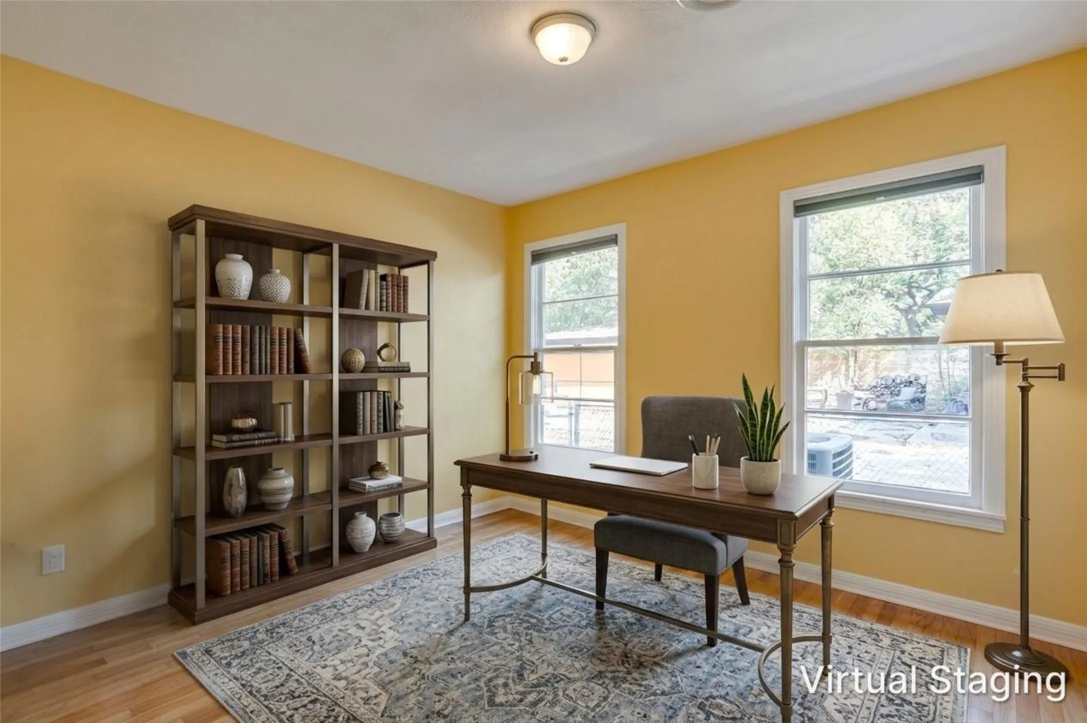 Hardwood flooring, two windows, recessed lighting, and a built-in bookshelf