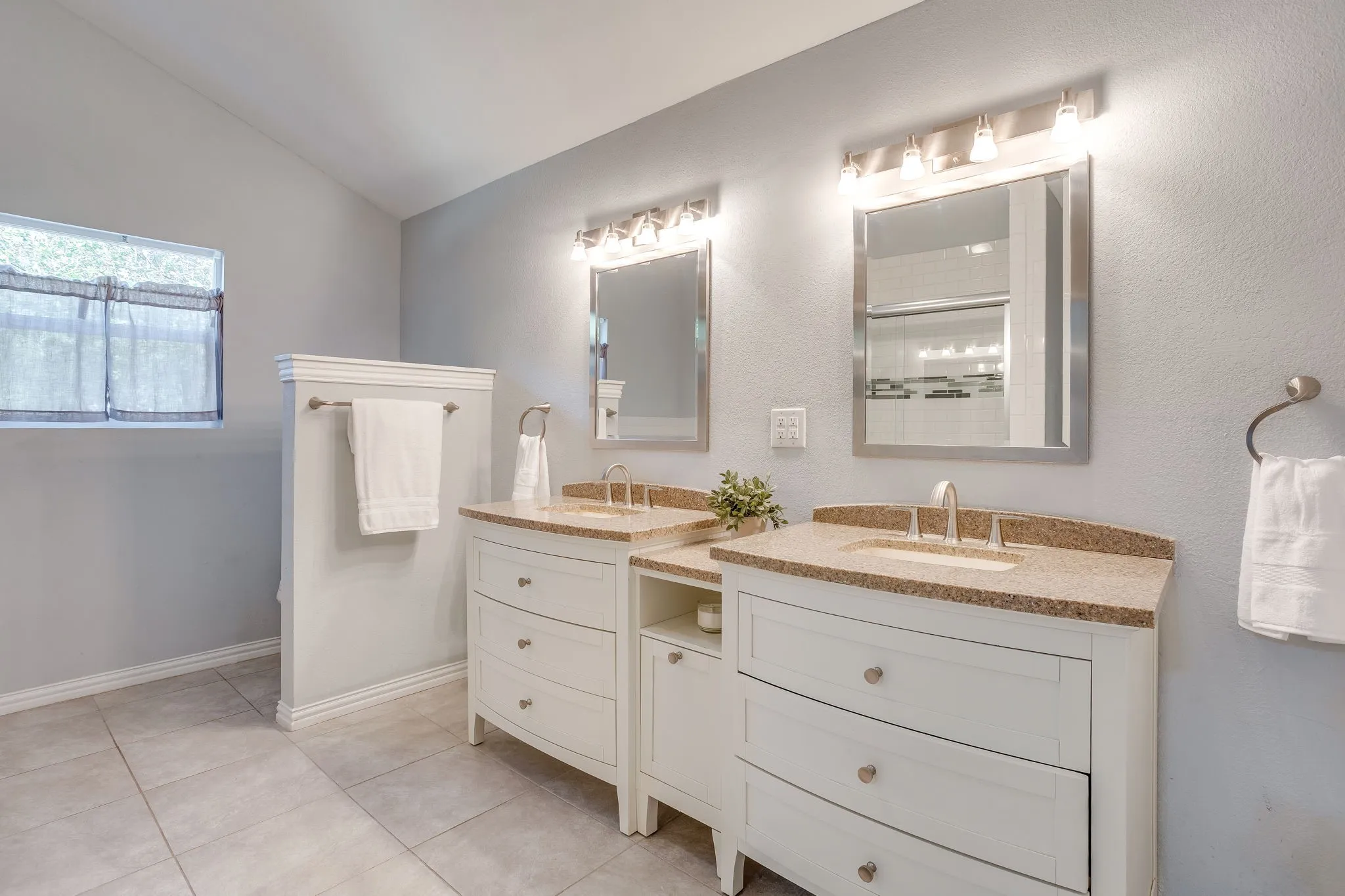 Dual vanity with integrated sinks, granite countertops, and brushed nickel fixtures