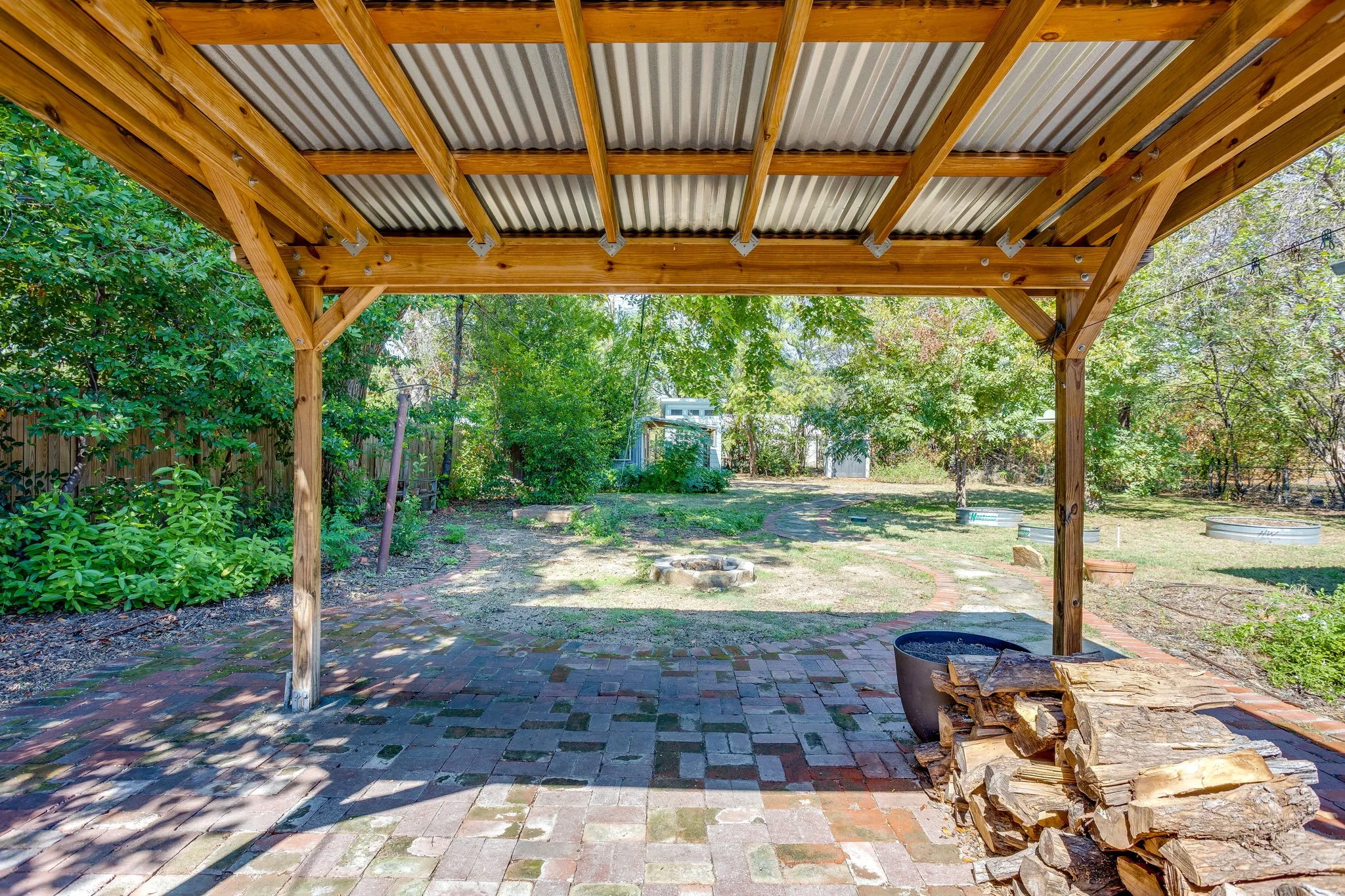 Covered patio with a corrugated metal roof and exposed wooden beams
