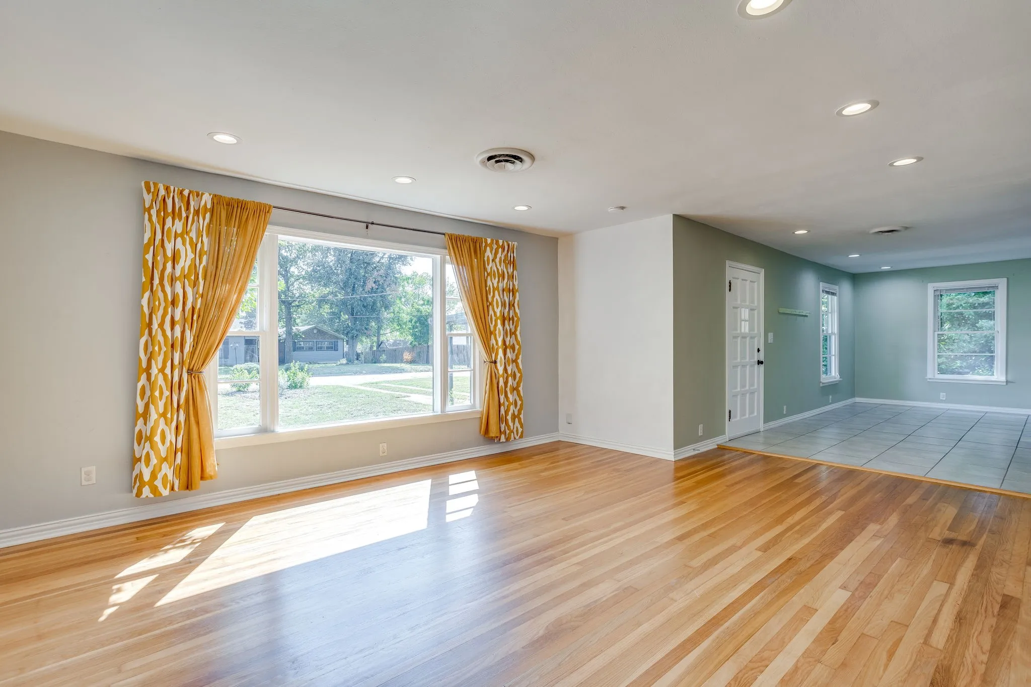Hardwood flooring, recessed lighting, and a large picture window