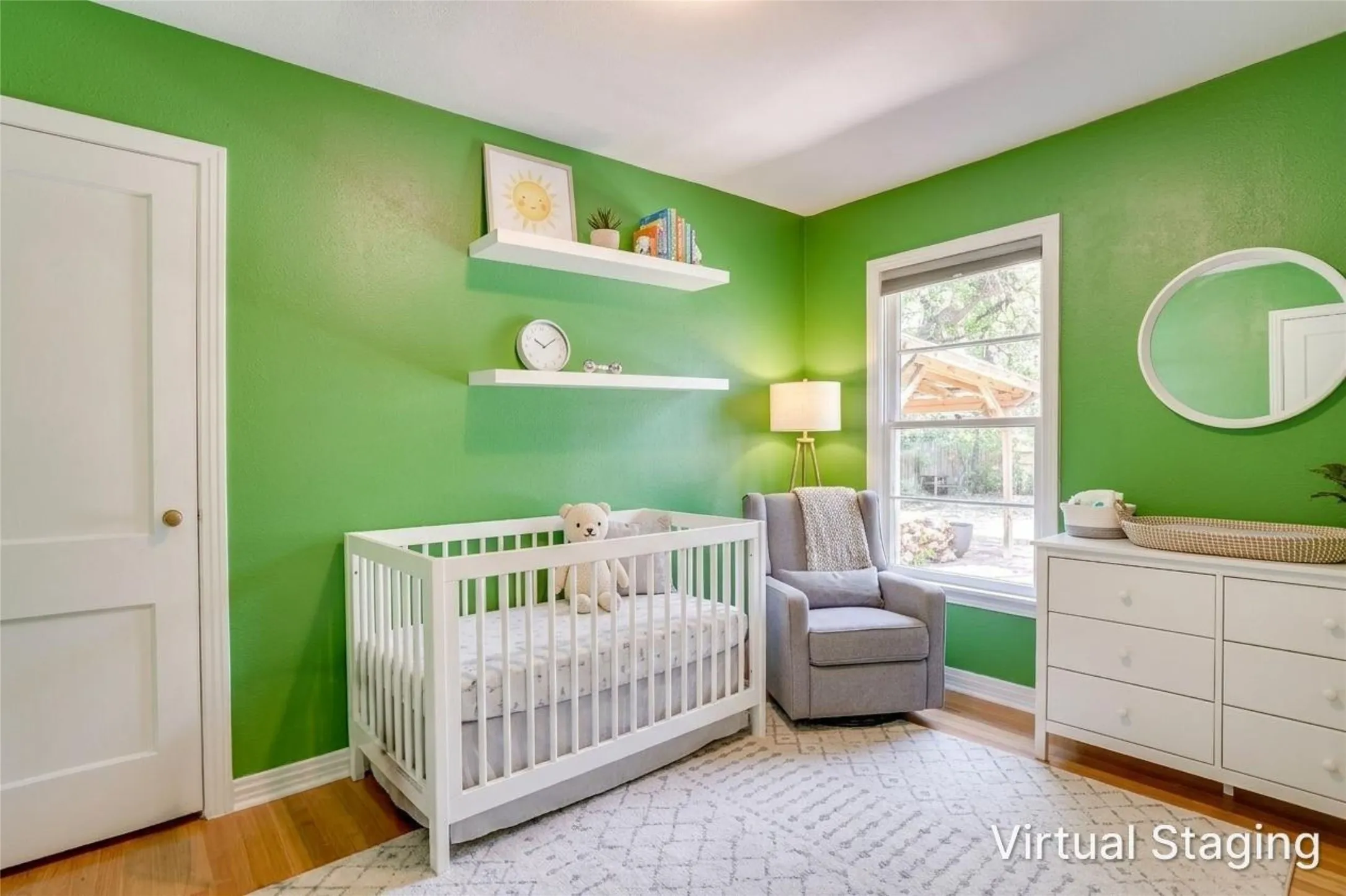 Hardwood flooring, painted walls, white trim, white interior door, and a single window