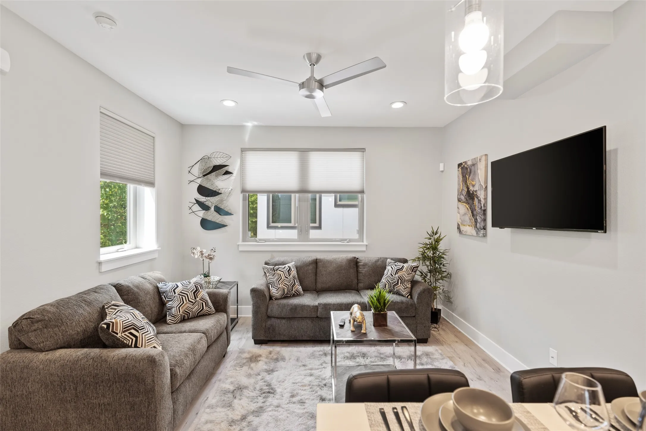 Recessed lighting, light wood-finish flooring, ceiling fan, and multiple windows