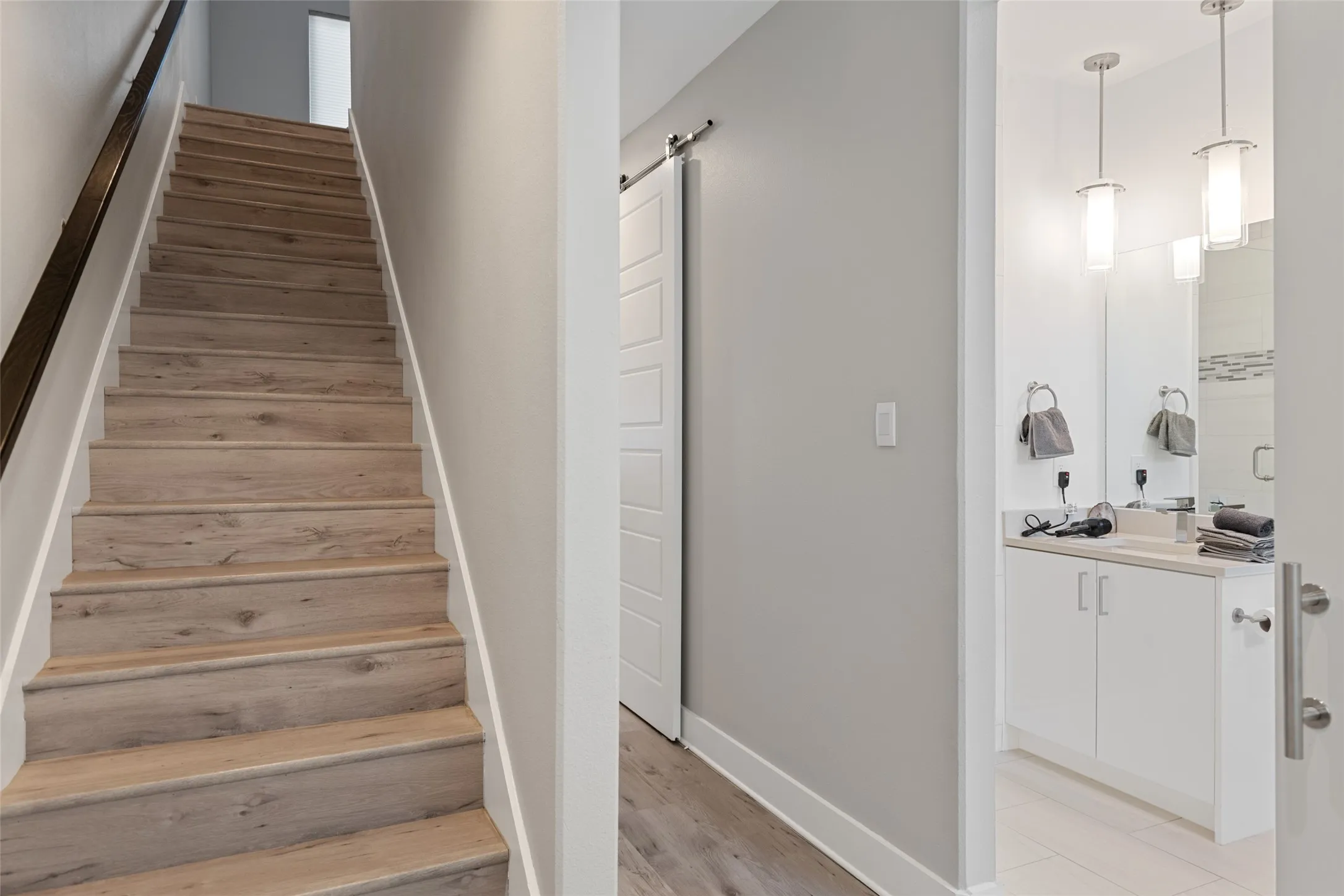 Wood-finish stairs with dark wood handrail