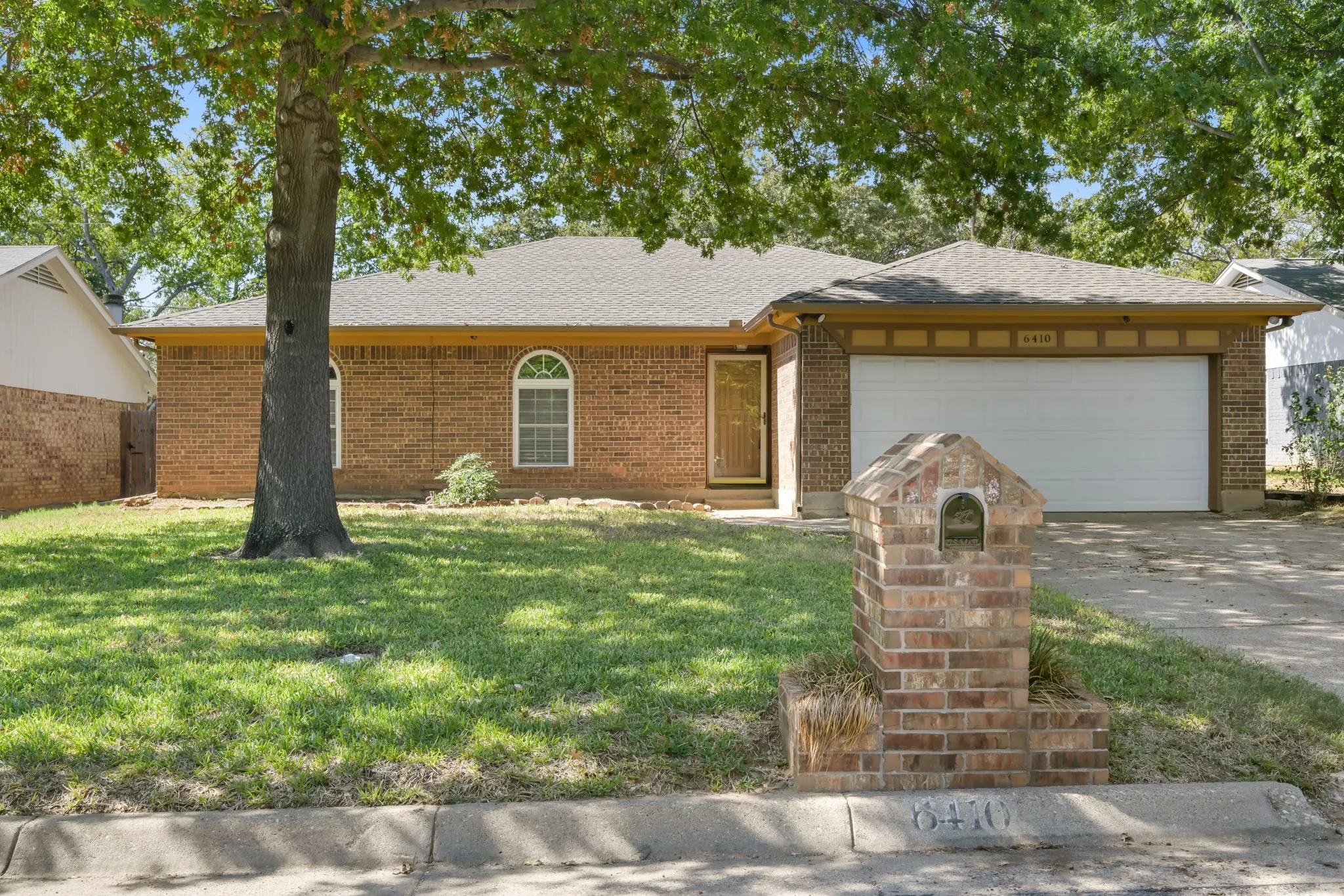 Classic curb appeal with towering trees!