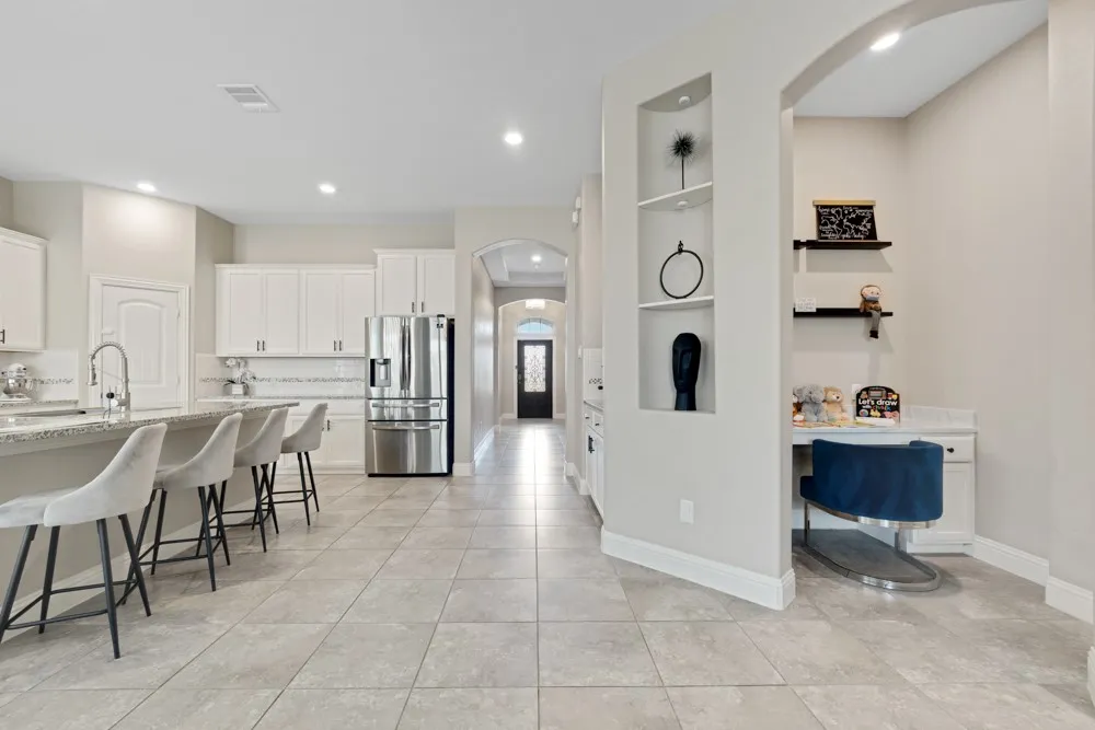 This nook’s built-in desk creates a tidy spot for organization, work, homework, or crafts, and its placement just off the kitchen and living area gives kids a sense of independence while keeping them easily within view.