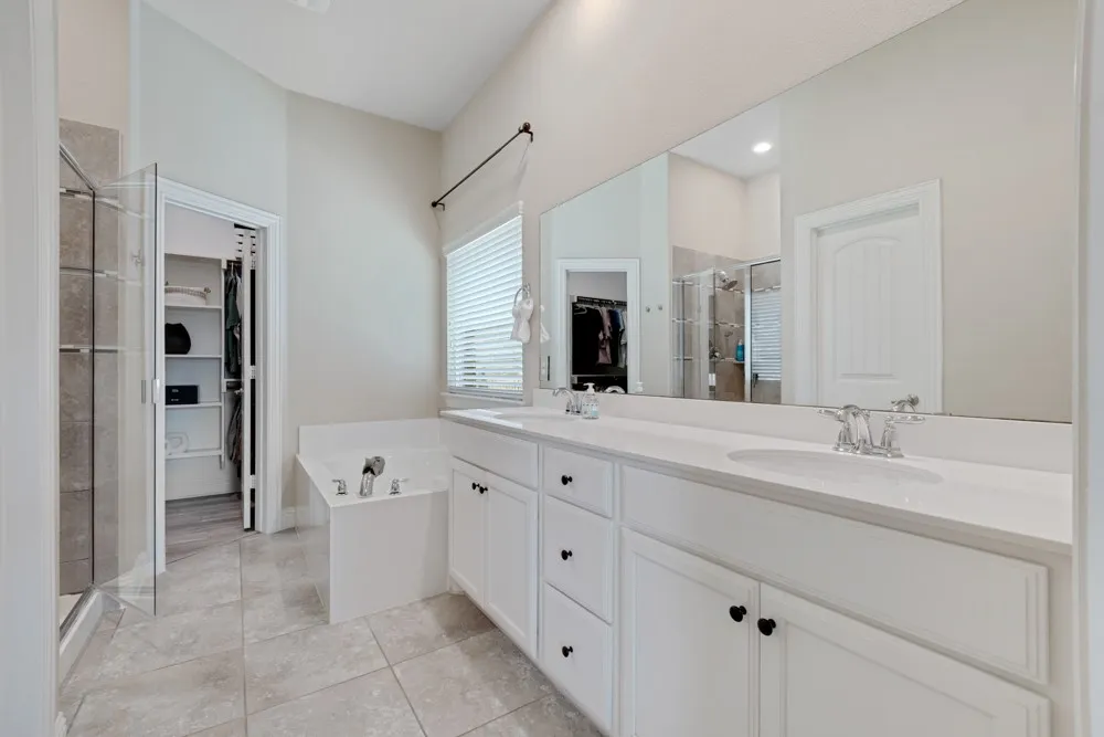 The Primary bathroom offers a dual sink vanity with plenty of countertop space & those oh so coveted vanity drawers in addition to a soaking tub, glass-enclosed shower, private water closet.