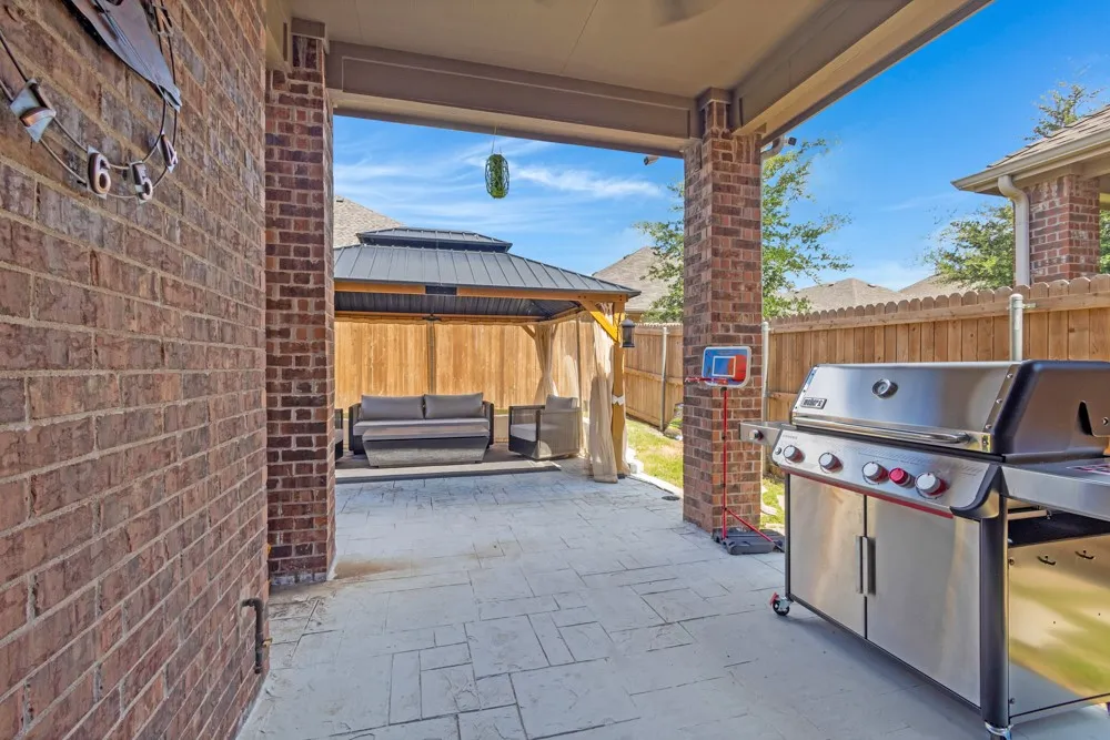 The outside space is where this home stands out over the rest!  Enjoy time on the covered patio grilling out or entertaining in the gazebo with curtains, a fan, heater, lighting and more.