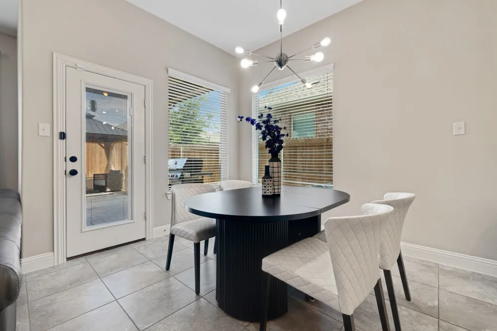 Enjoy gatherings in the dining area that opens to the kitchen and living space and overlooks the covered patio and backyard space.