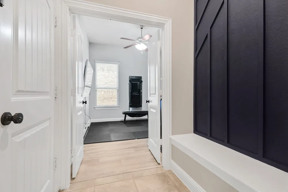 This mud bench area off the garage offers ease and organizational opportunities as you enter the home.  French doors lead into the study.