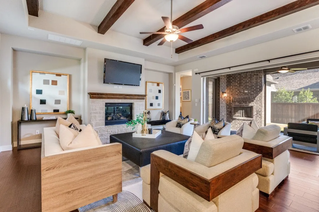 Living Room has triple fold glass doors opening onto screened patio with fireplace & gas logs.
