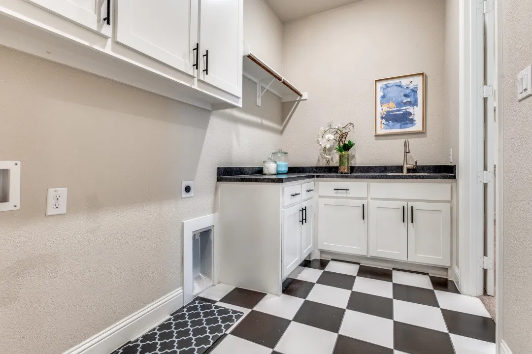 Laundry room with sink & lots of cabinets.