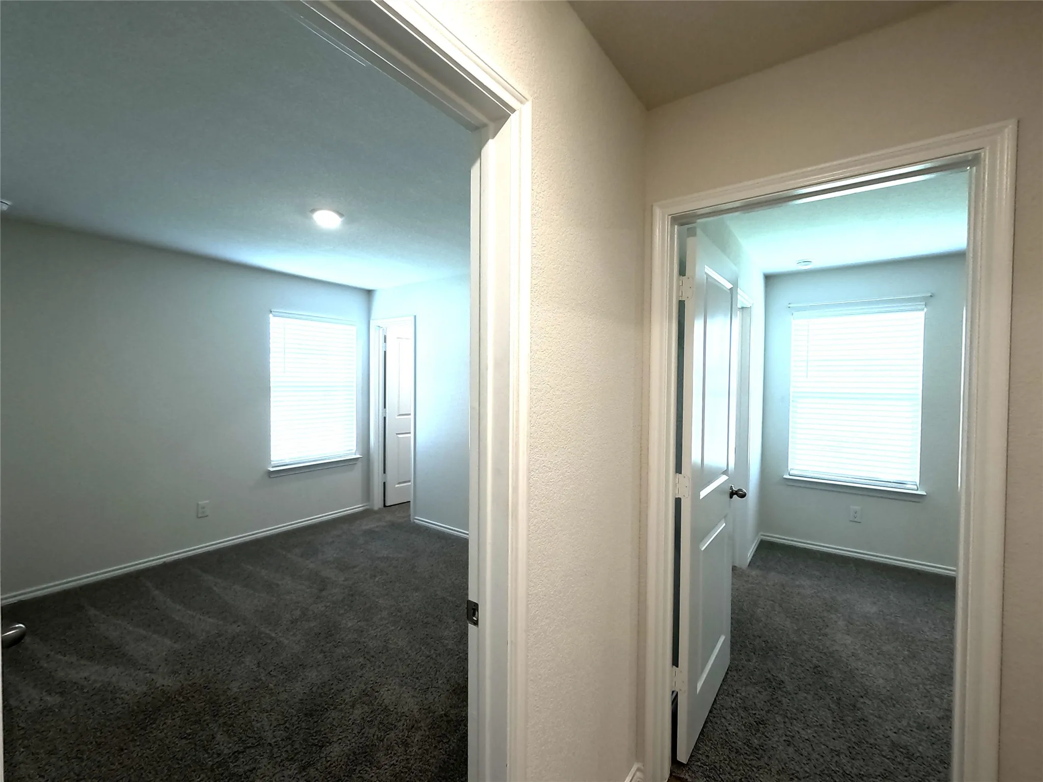 Two rooms featuring neutral wall tones, recessed lighting, and windows with blinds