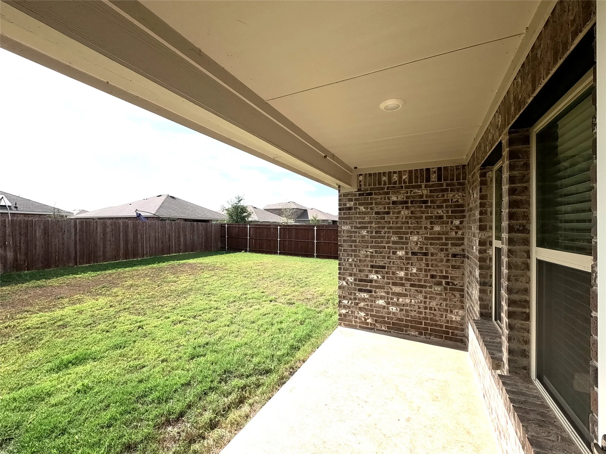 Covered patio with a concrete surface and recessed lighting