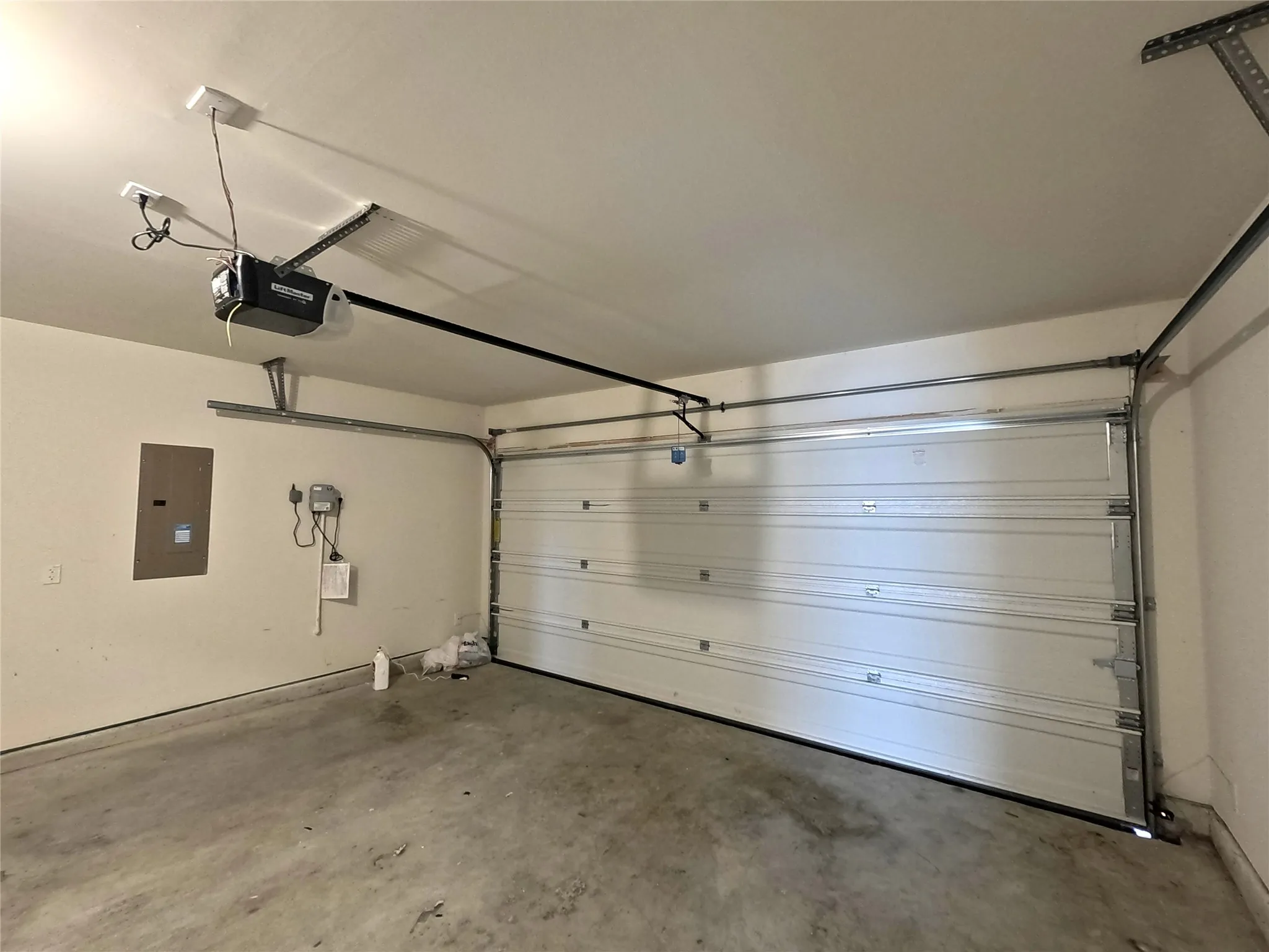 Attached garage featuring a sectional overhead door with automatic opener