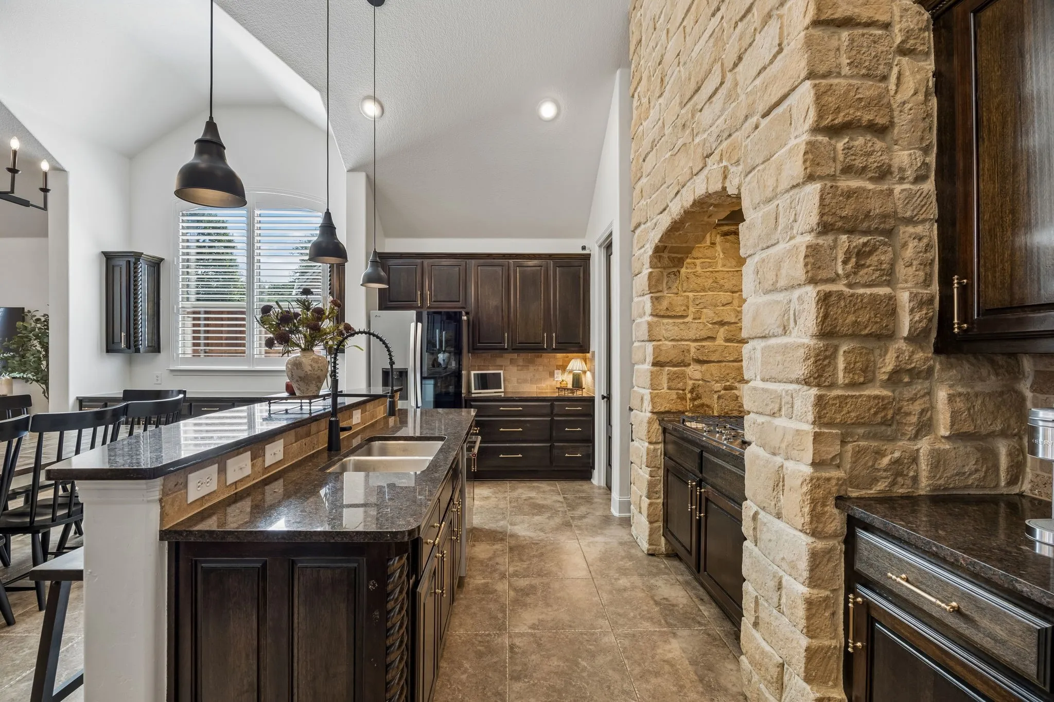 Here you can see the arched stone surround and the dark cabinetry