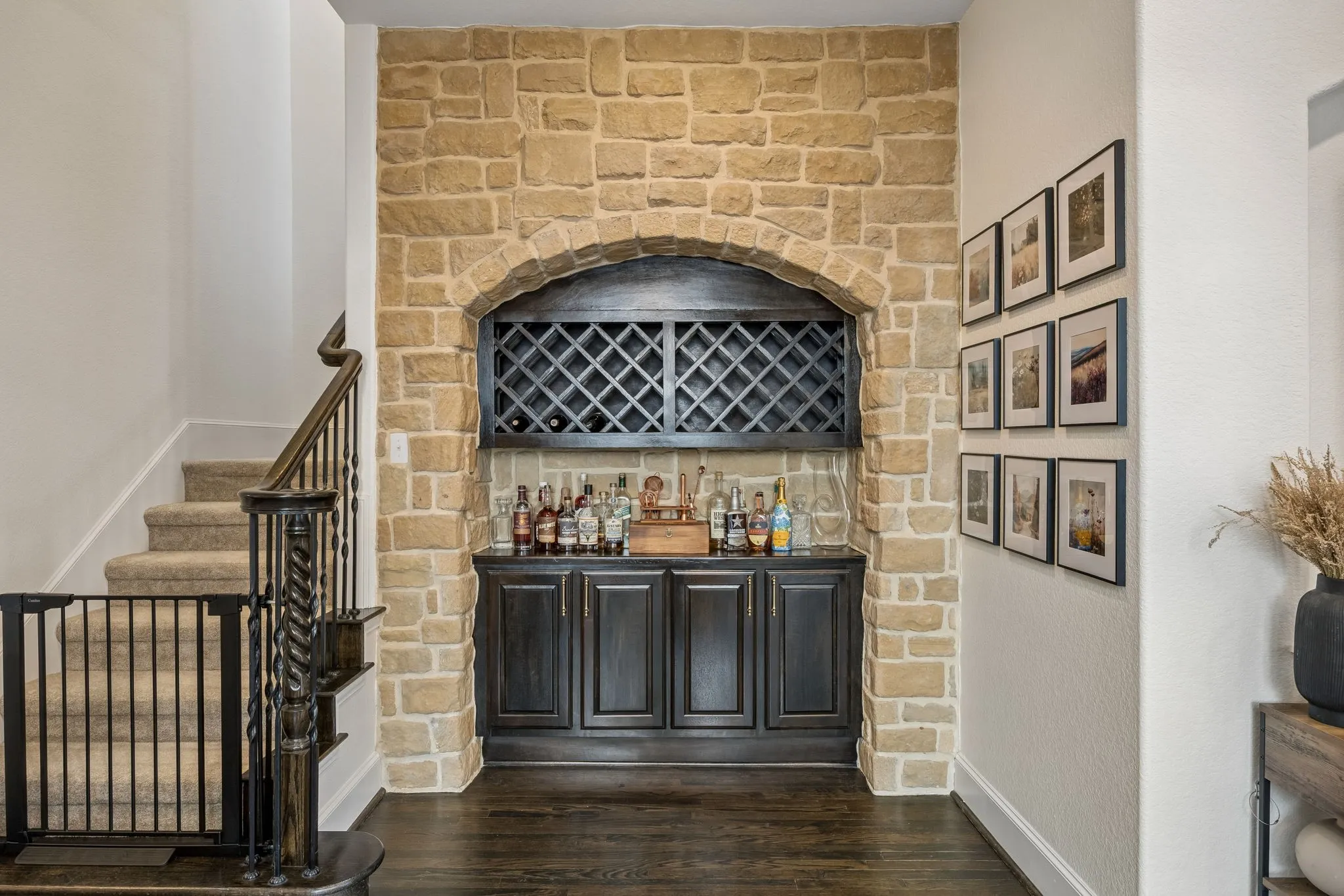 Built-in stone archway with a bar including wine storage
