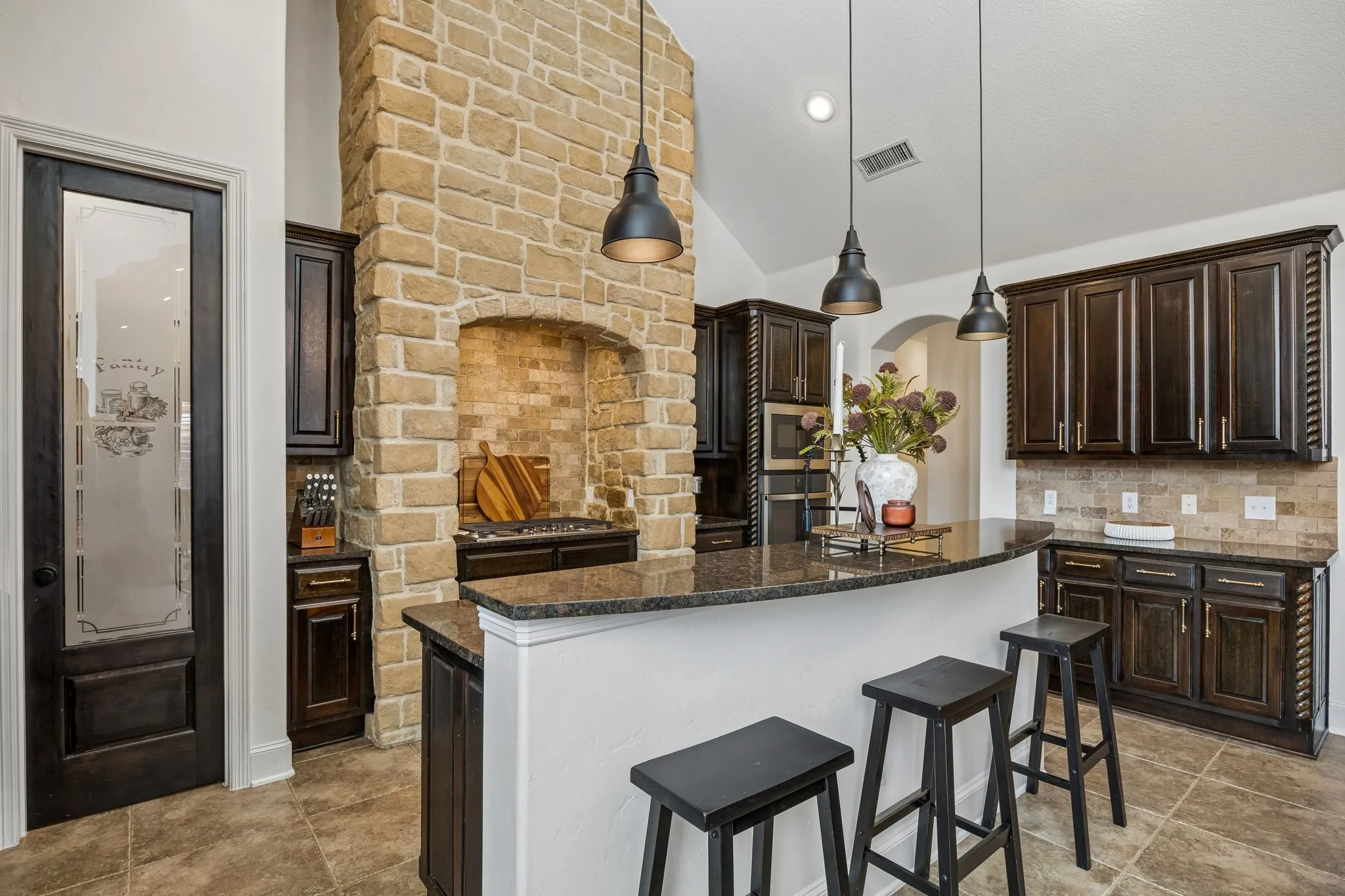 The gas cooktop is inside of a stone surround.