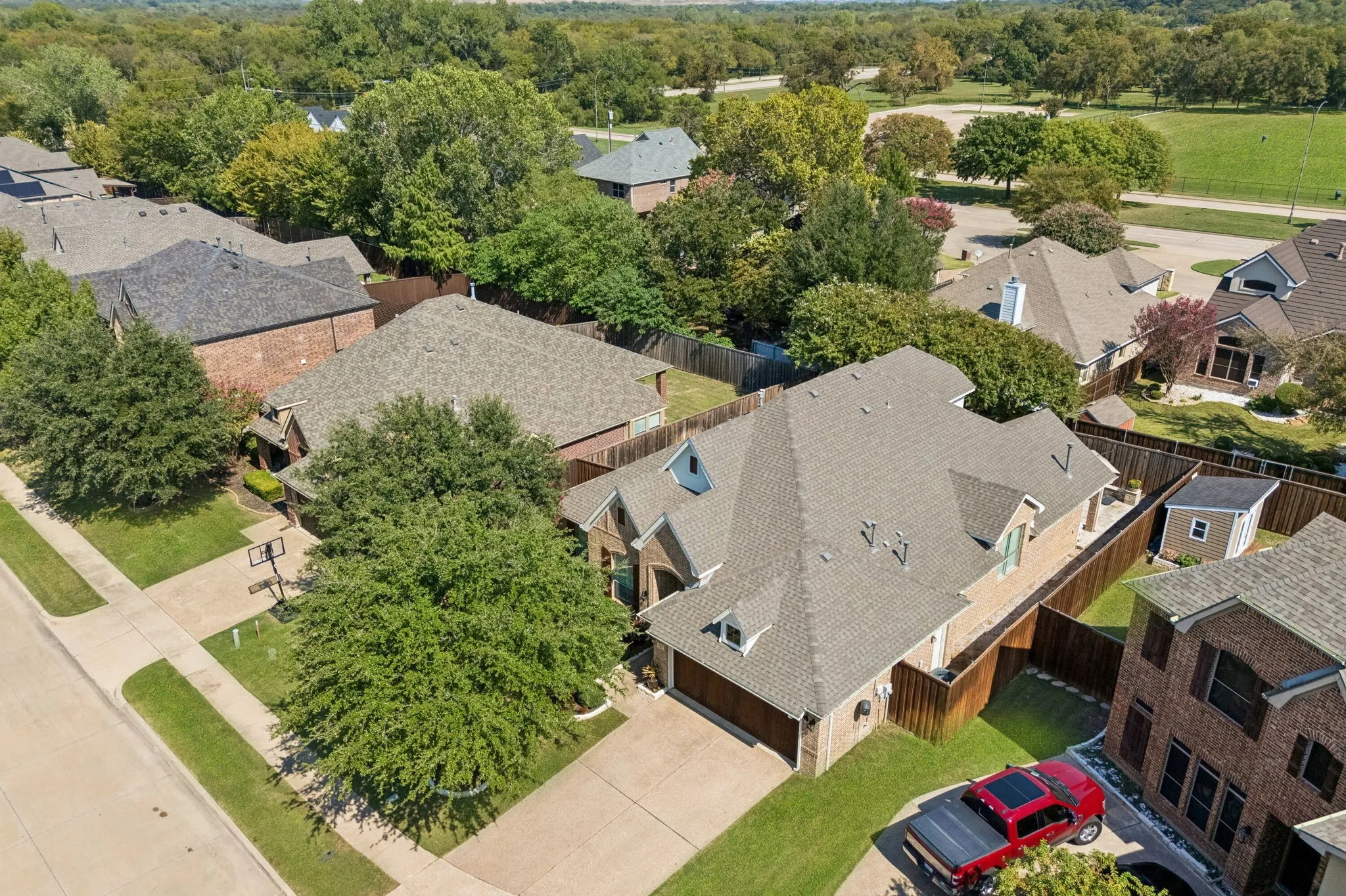 Another aerial view showing the attached garage and wood privacy fence