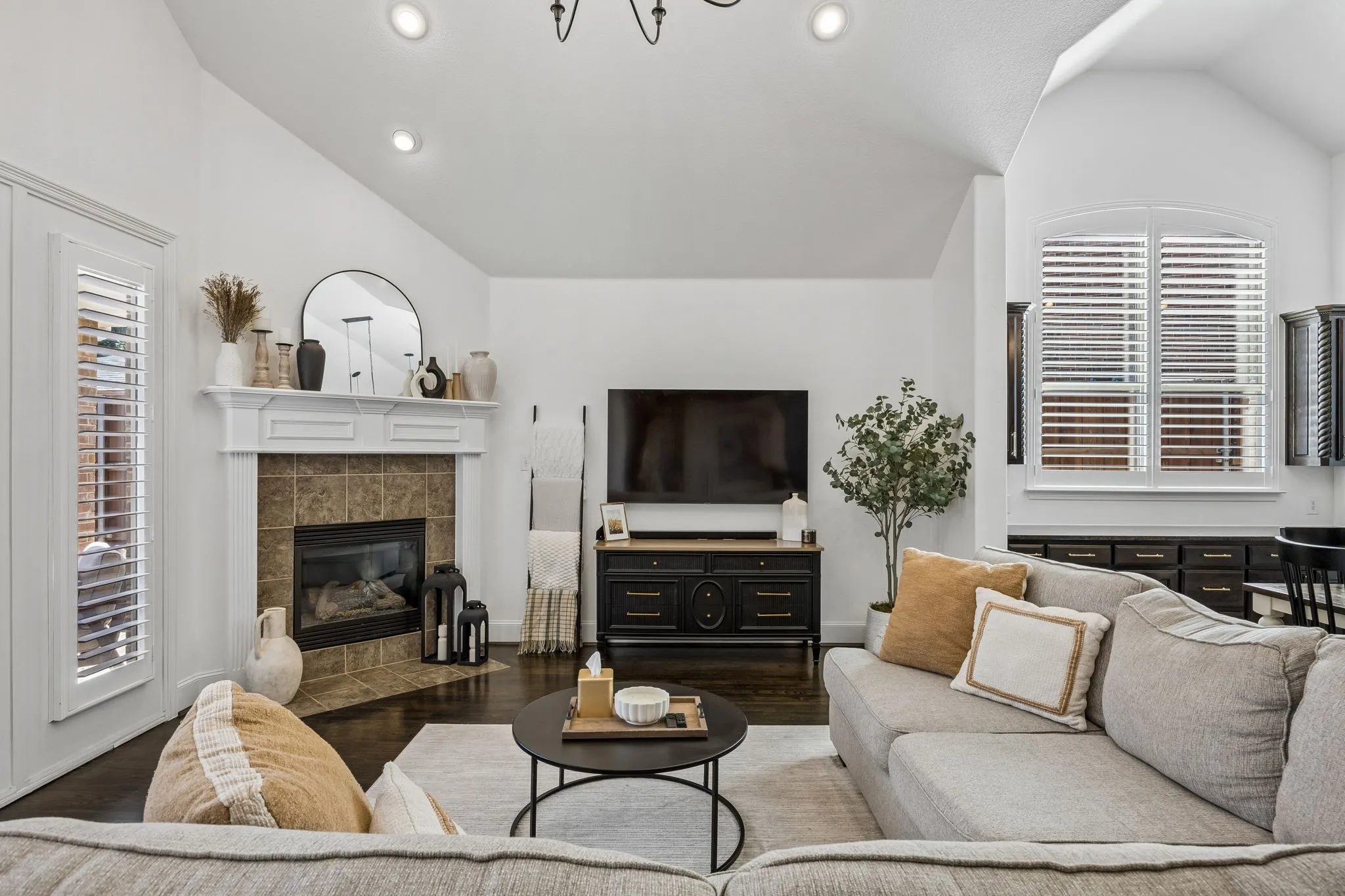 Living room with a fireplace and recessed lighting.
