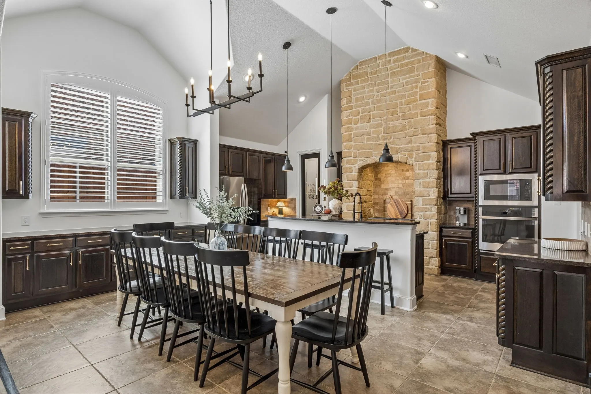 The dining area and kitchen feature vaulted ceilings, abundant cabinetry and modern lighting