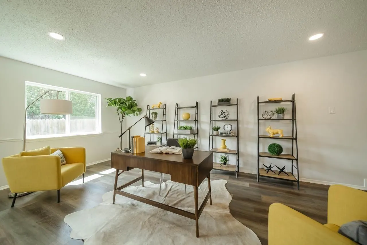 Room featuring wood-finish flooring, recessed lighting, and a large window with white casing