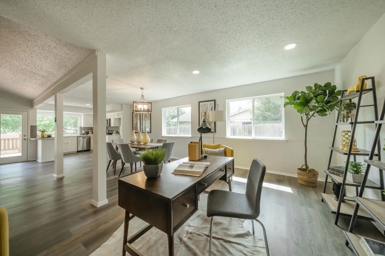 Open-concept interior featuring wood-finish flooring, recessed lighting, and multiple large windows