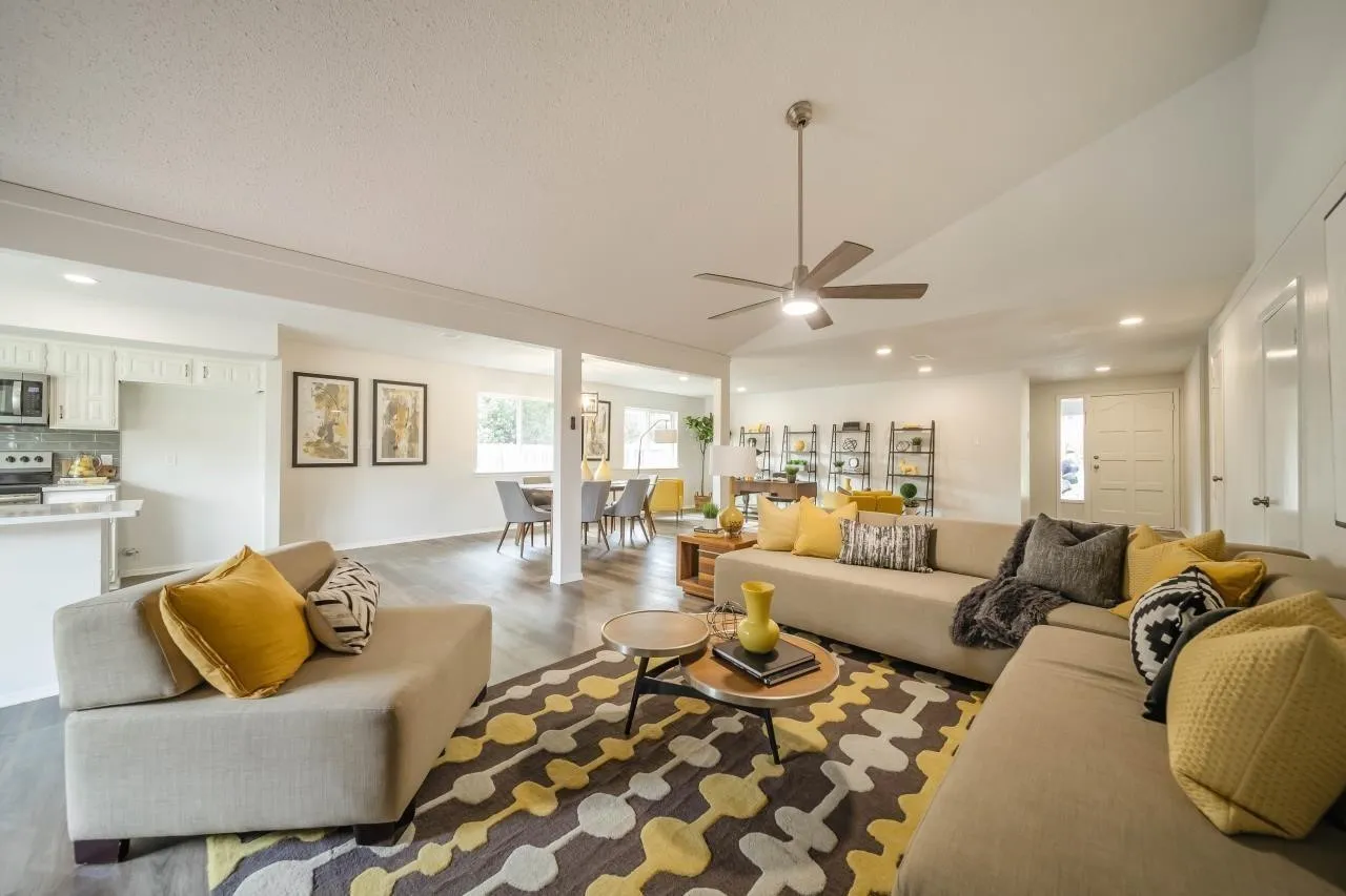 Vaulted ceiling, open-concept floor plan, recessed lighting, wood-finish flooring, and brushed metal ceiling fan