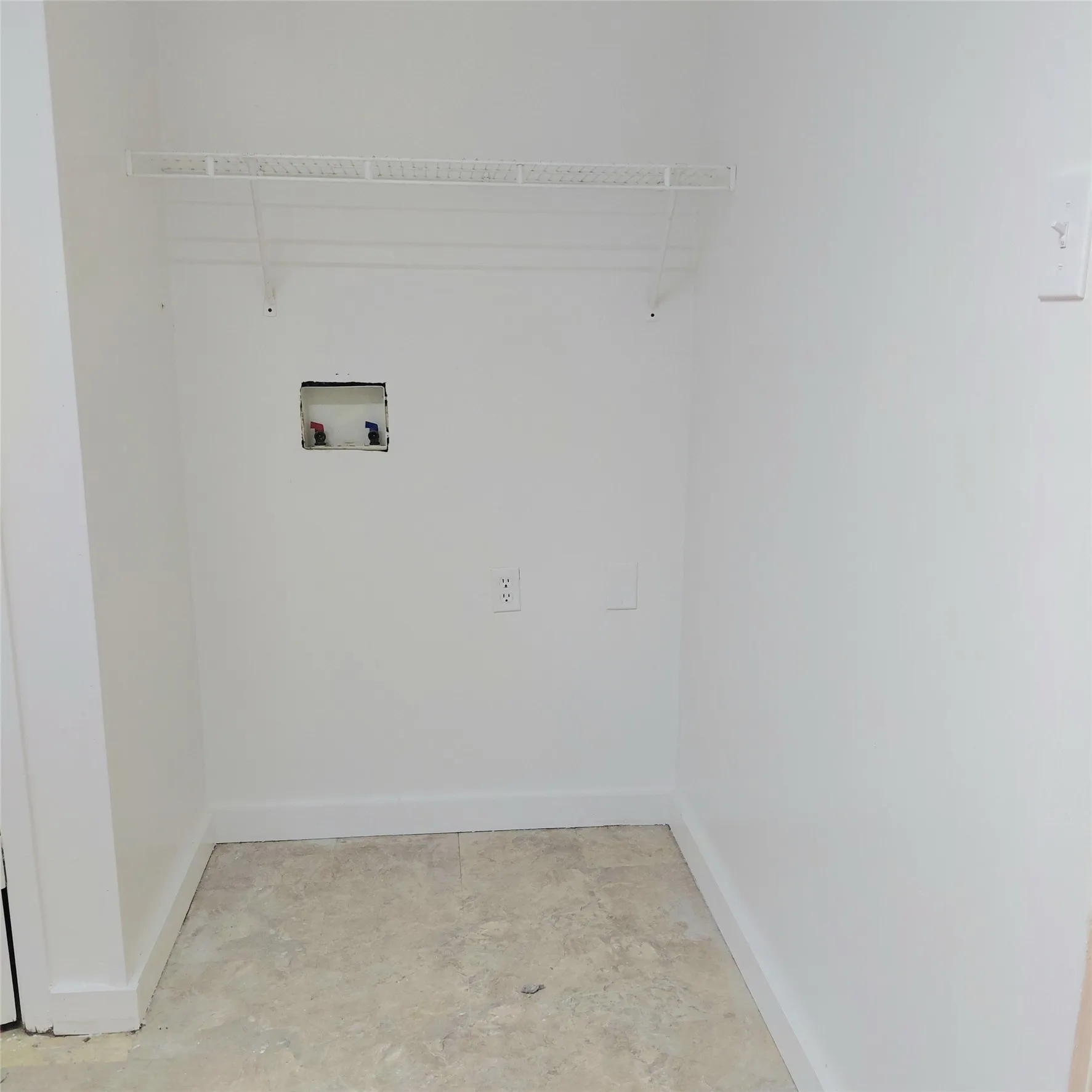 Laundry area featuring a wire shelf, tile flooring, and dedicated hookups