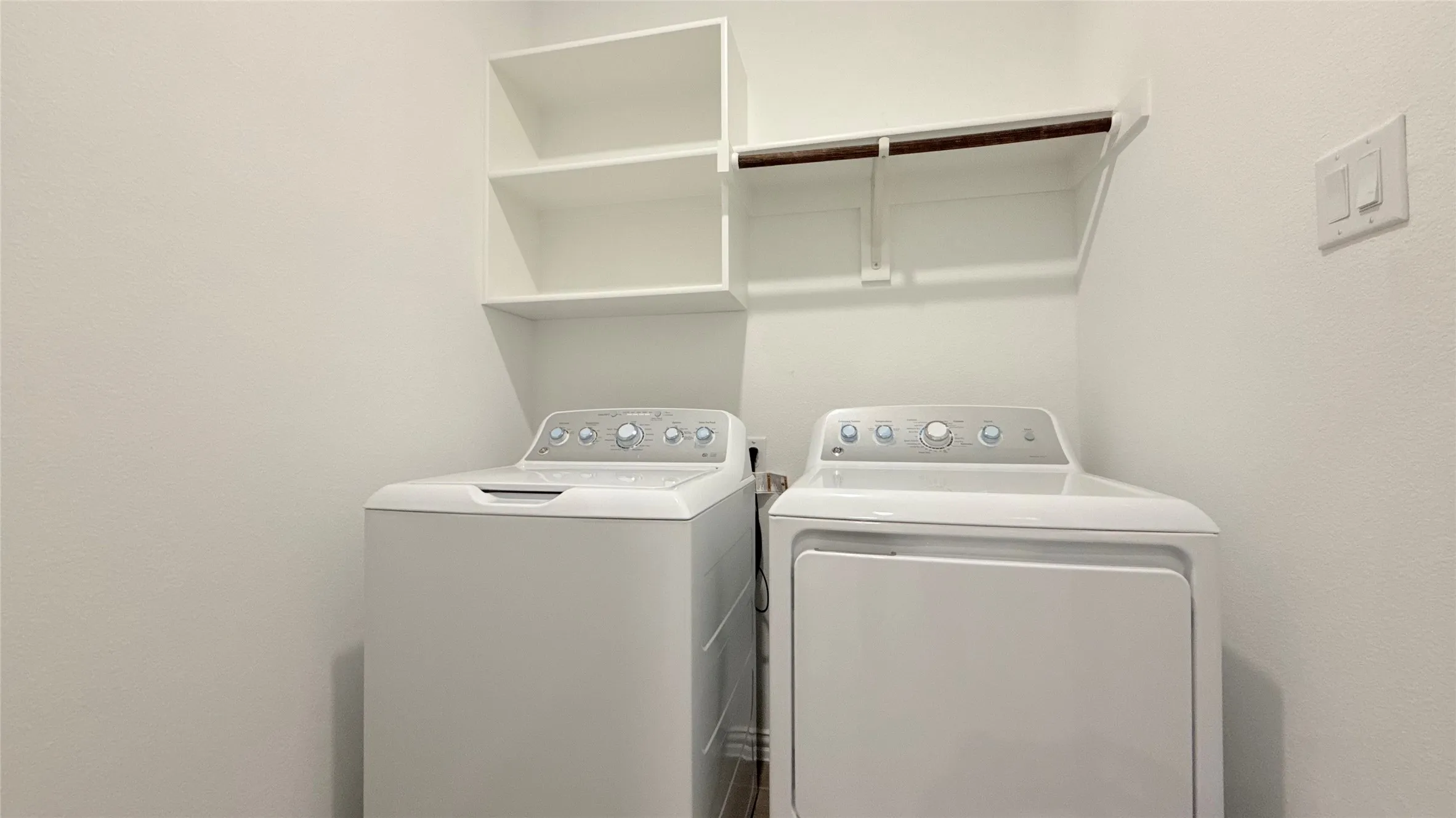 Built-in shelving and a clothing rod provide organized storage