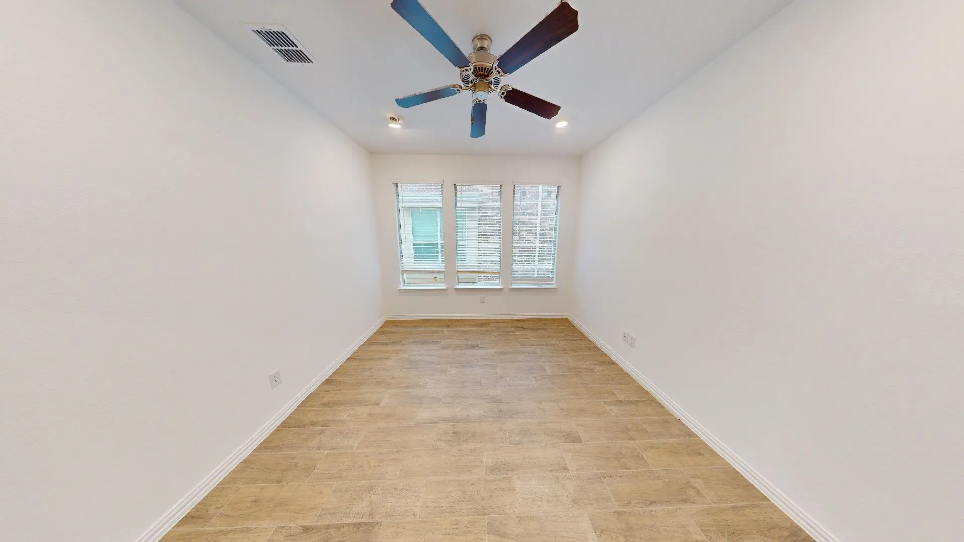 Recessed lighting, ceiling fan, three windows, wood-finish flooring, white wall paint