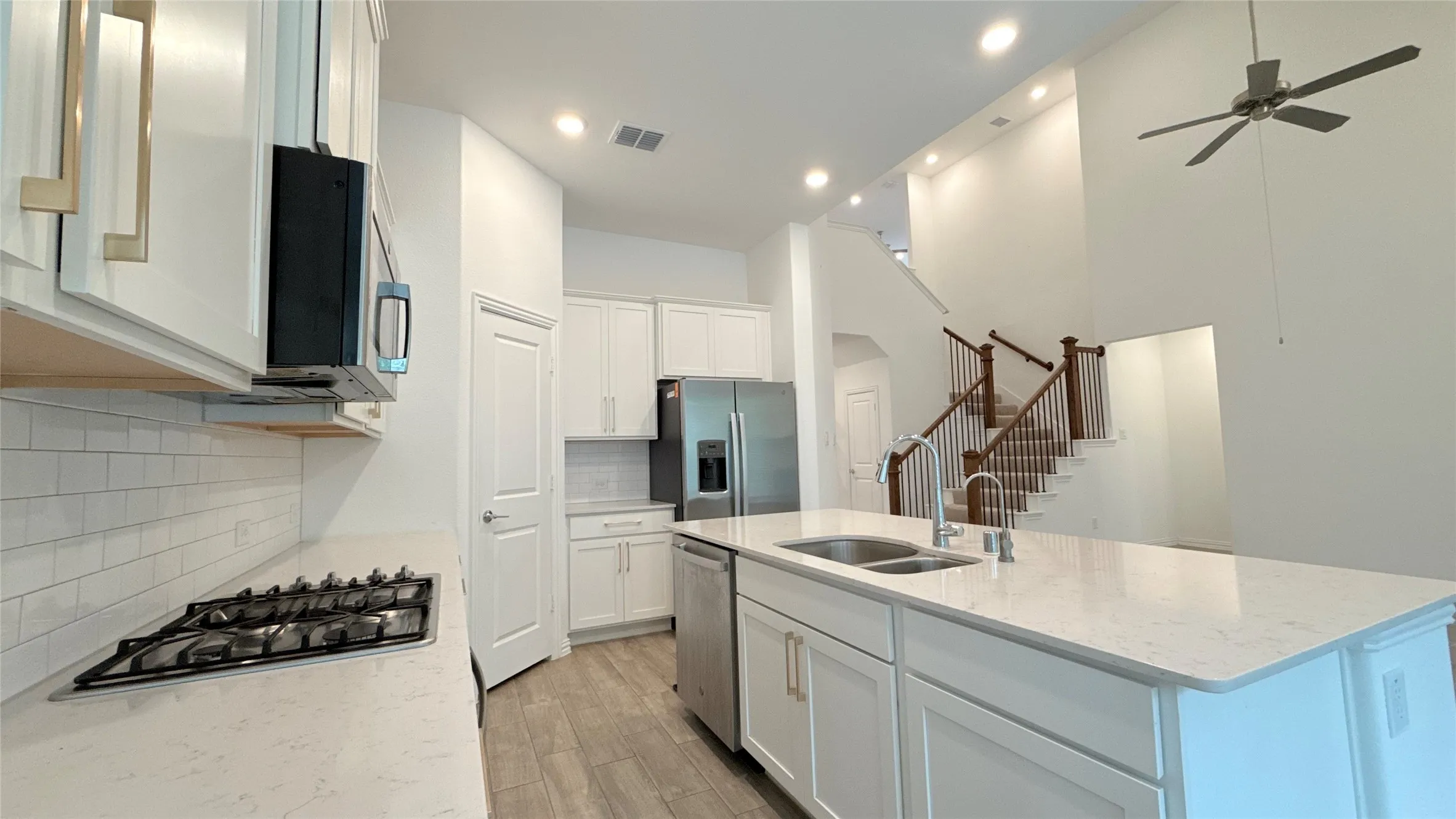 Gourmet kitchen featuring a gas cooktop, white subway tile backsplash, and stainless steel appliances