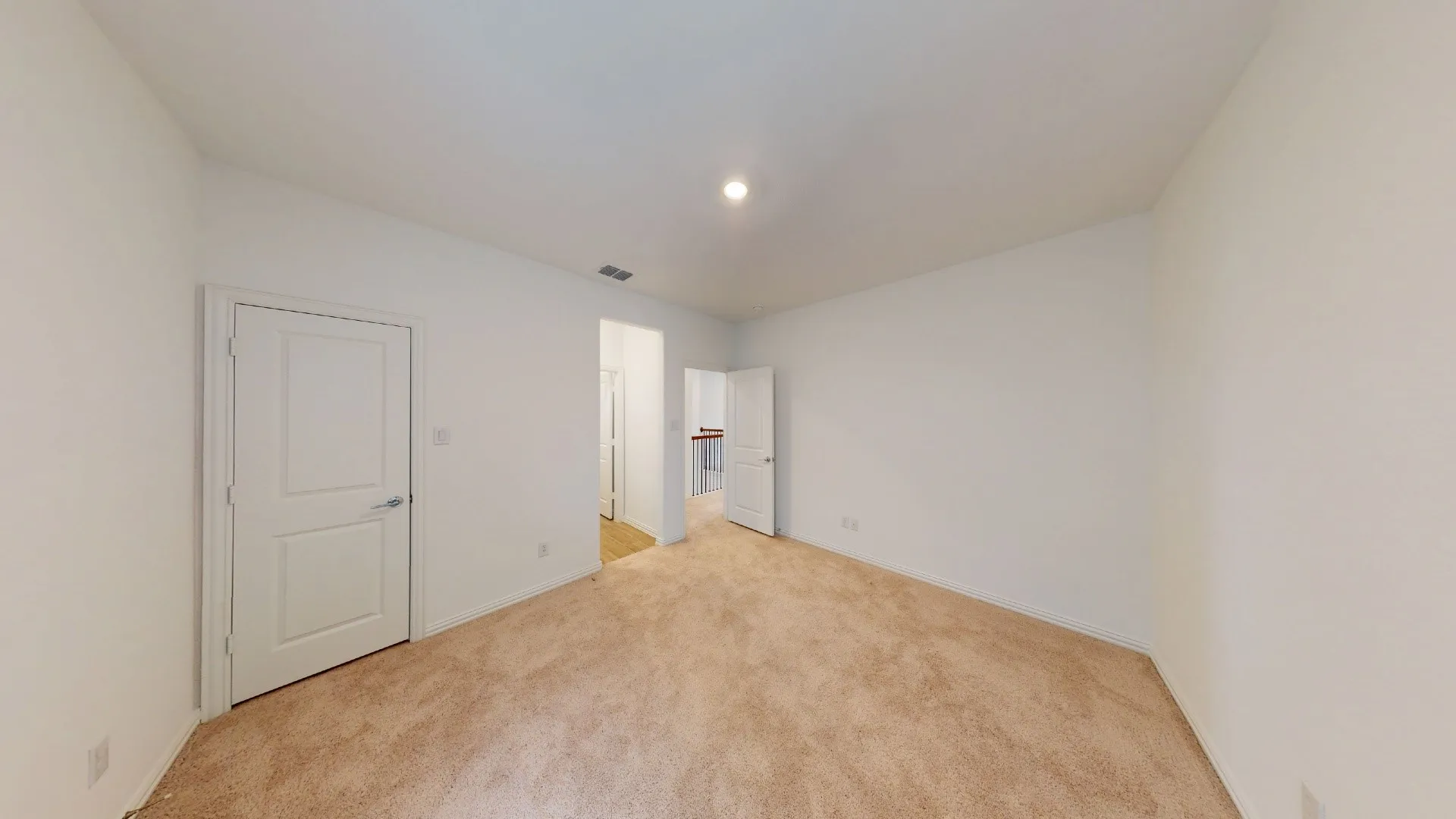 Carpeted flooring, white walls, white doors, and recessed lighting