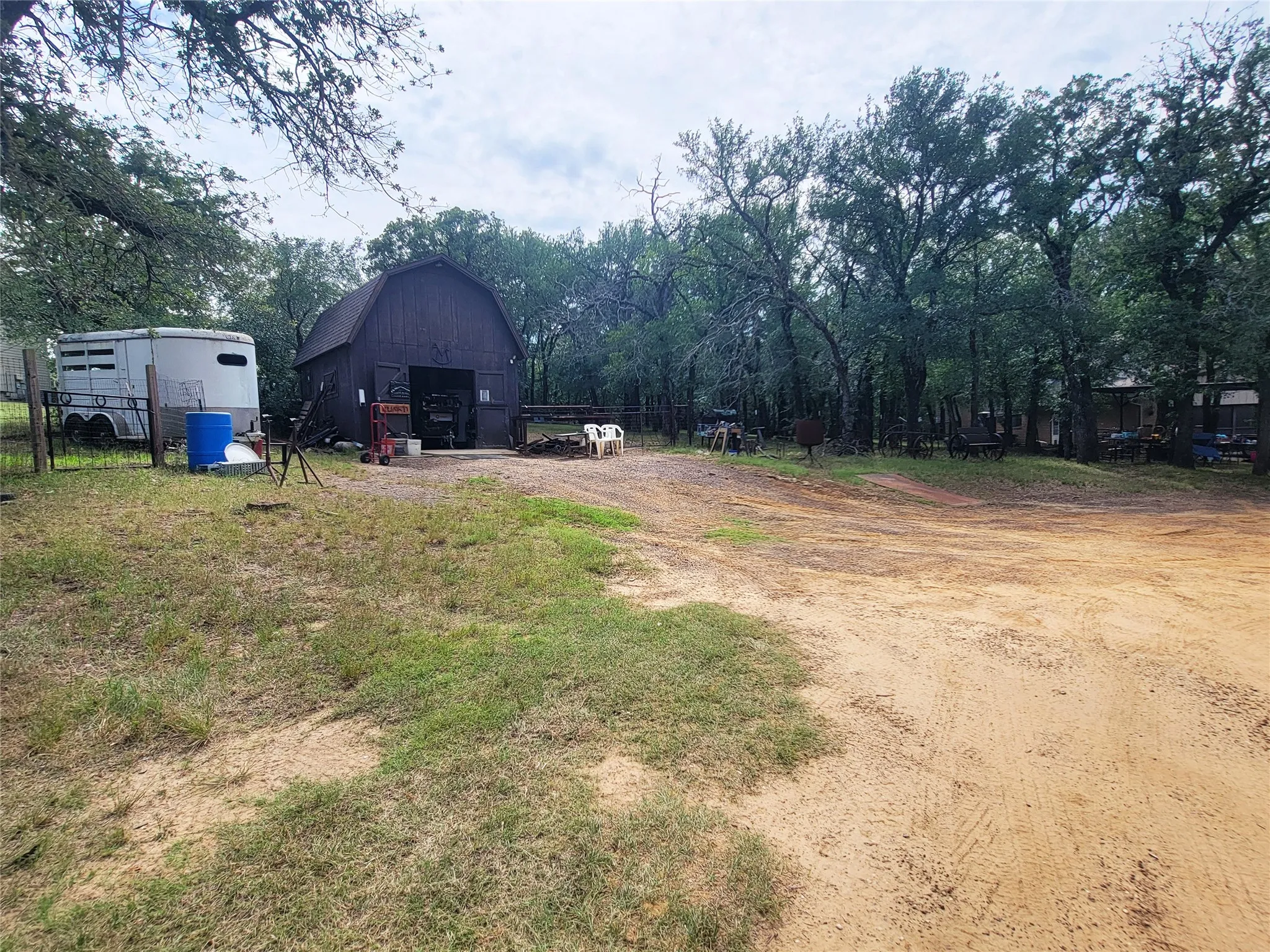 Gambrel roof barn with wood siding and large open entry