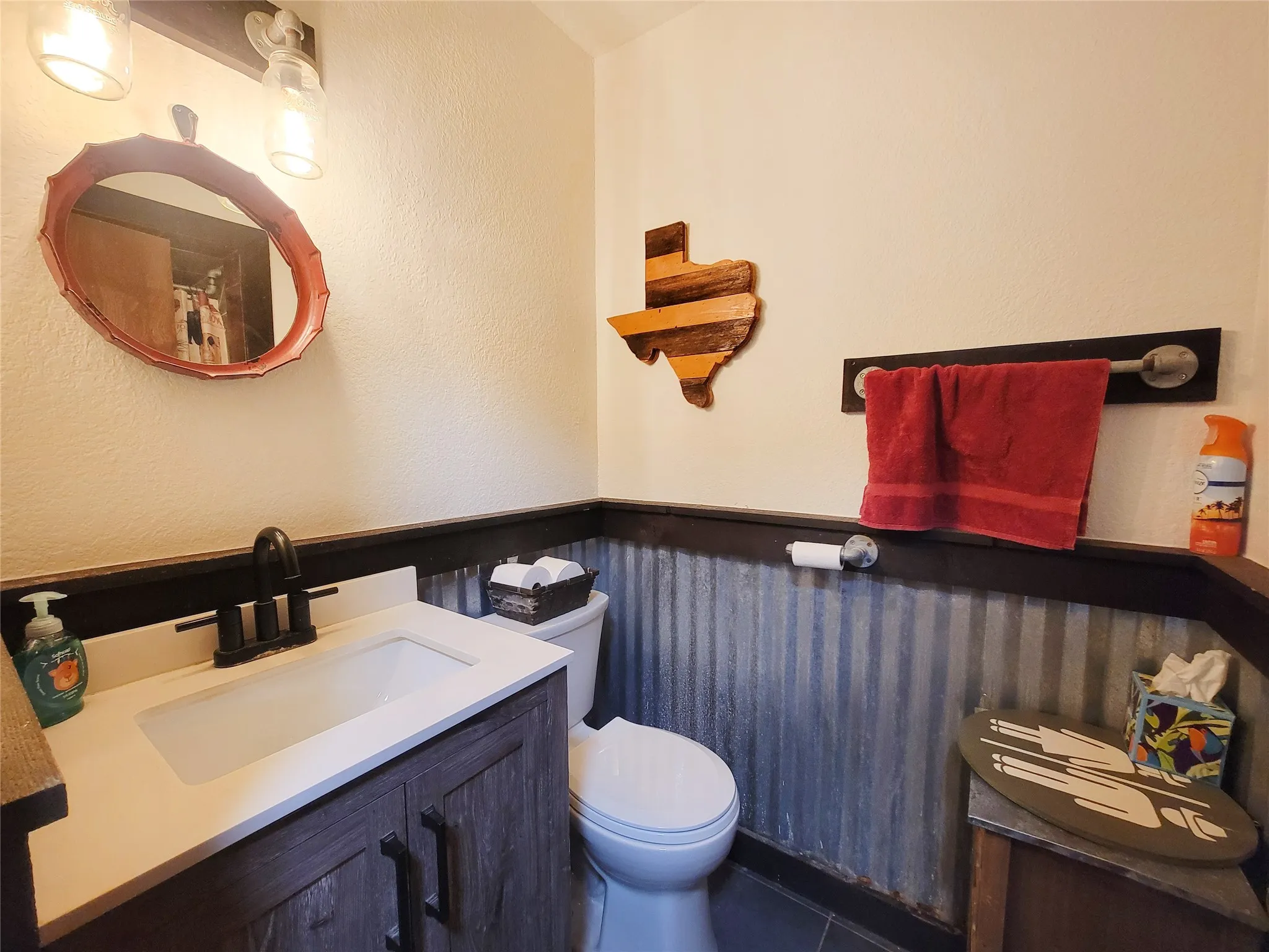Vanity with integrated sink, black faucet, and white countertop
