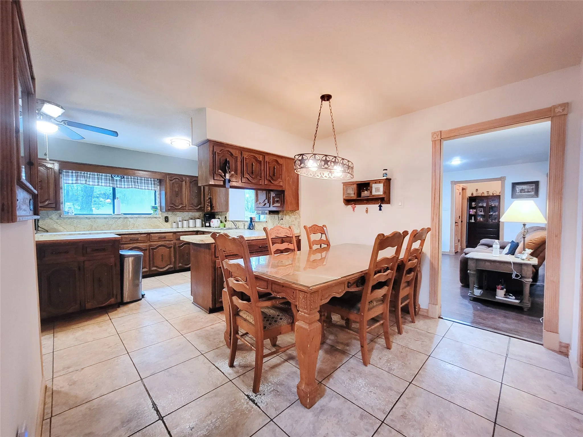 Kitchen featuring wood cabinetry, light-toned countertops, and tiled flooring