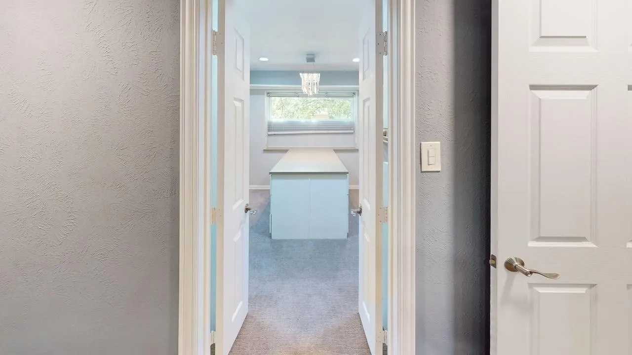 Double-door entryway featuring six-panel interior doors, recessed lighting, and a central built-in island with a flat surface