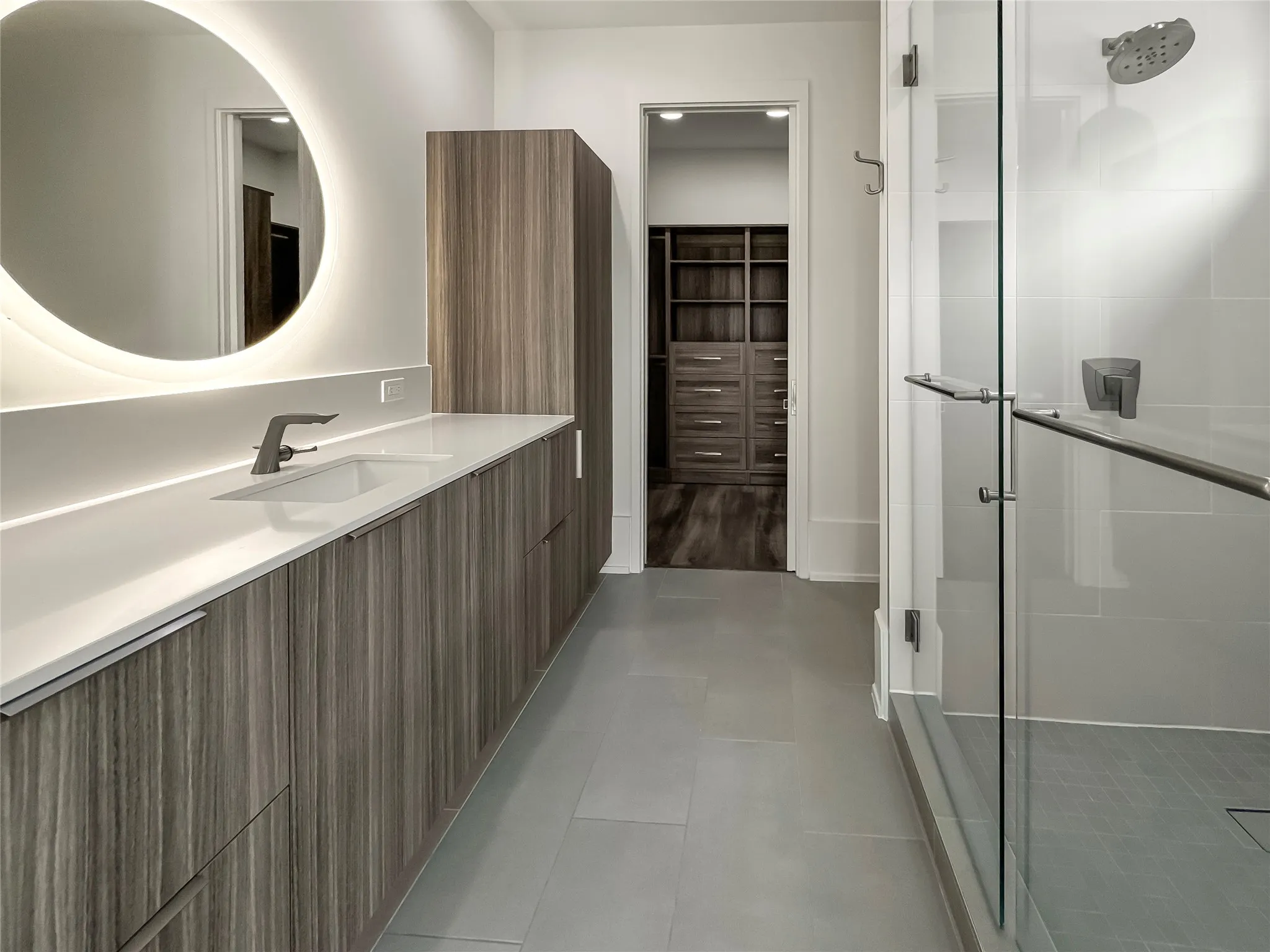 Bathroom featuring vanity, tile patterned floors, and walk in shower