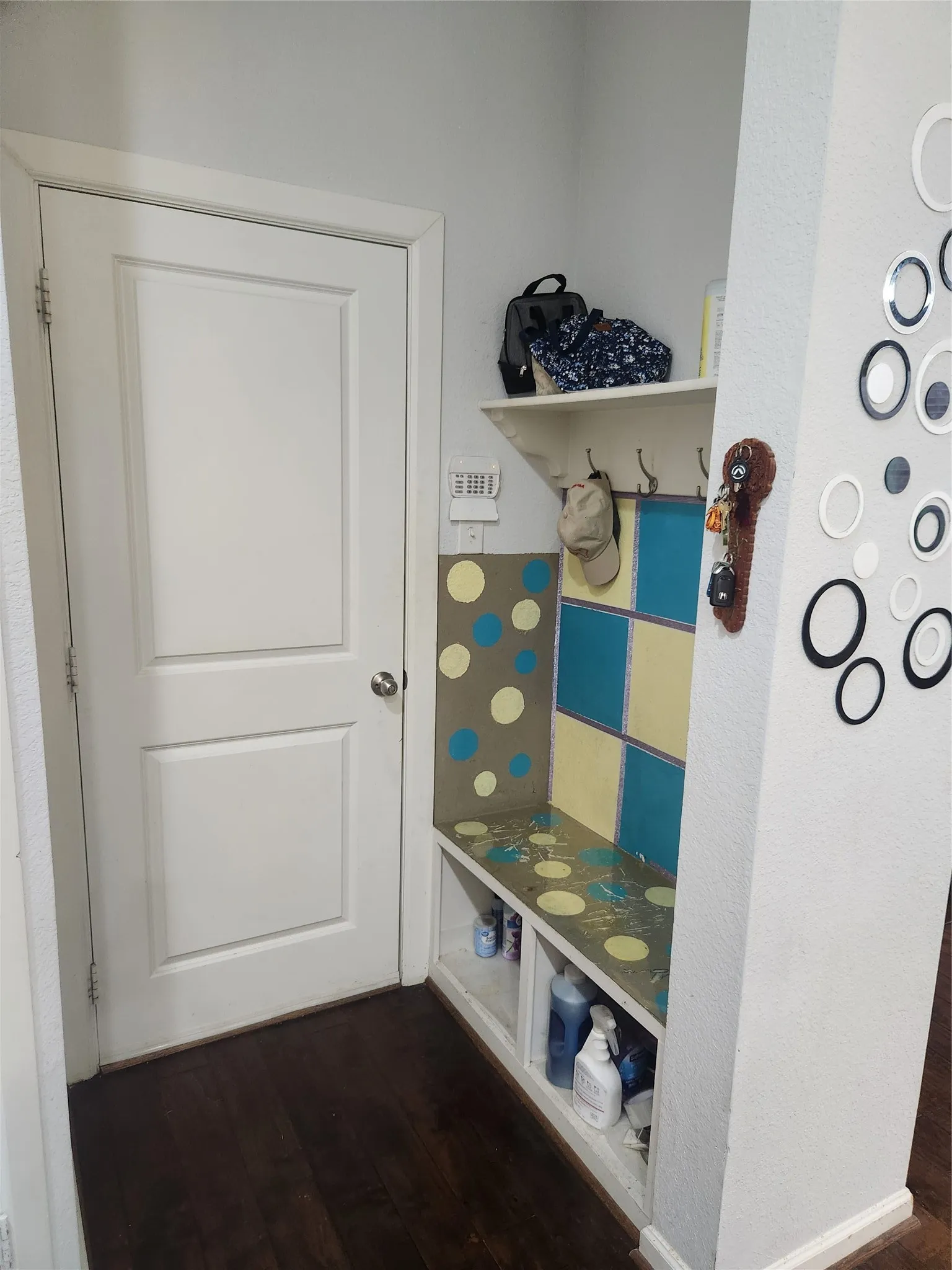 Built-in storage bench with overhead shelf and coat hooks
