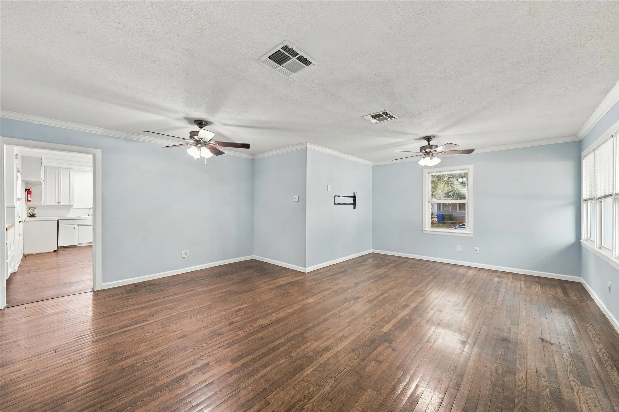 spacious livingroom with hard wood flooring and double pane windows
