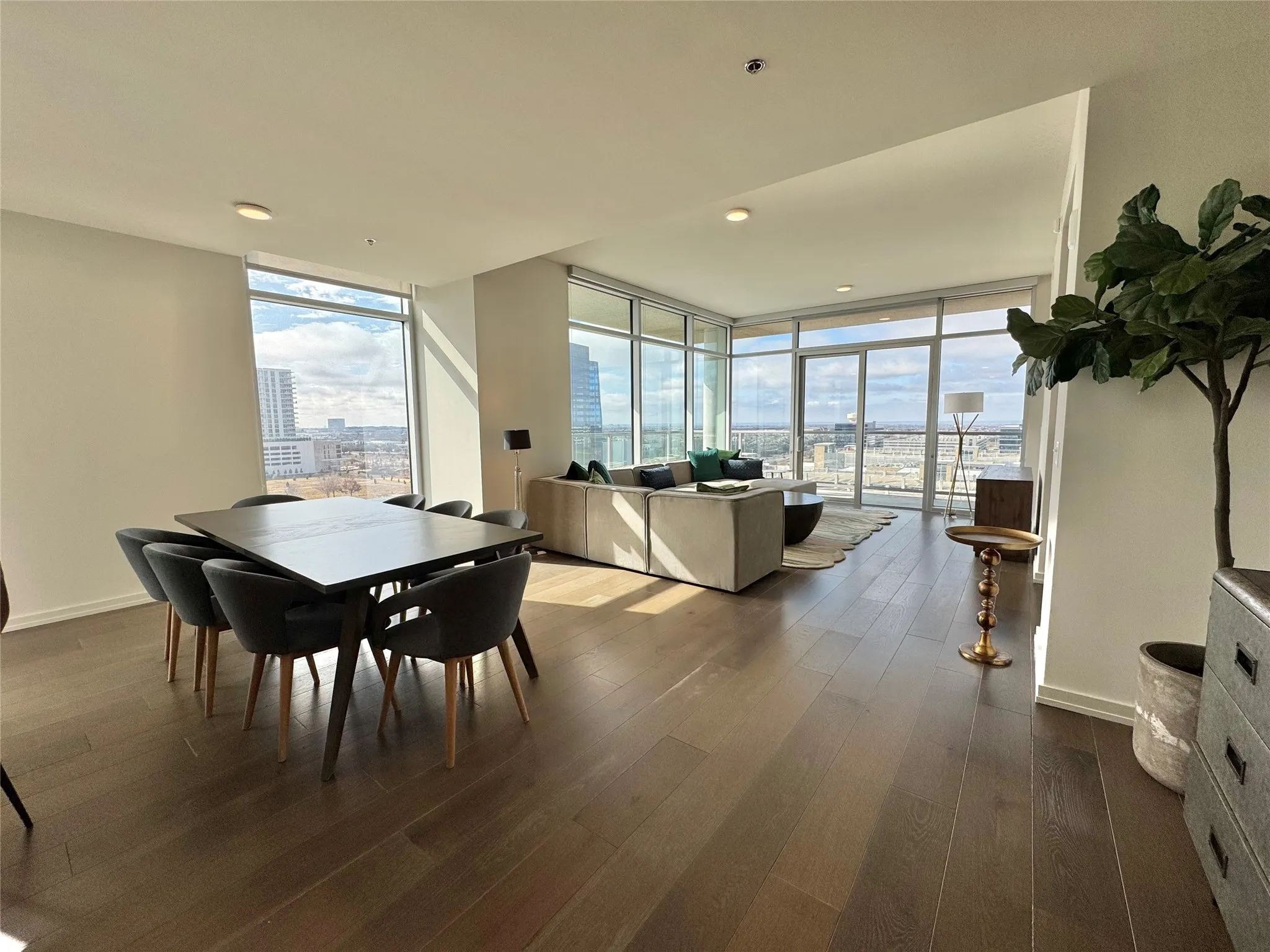 Dining area with expansive windows and dark hardwood / wood-style flooring