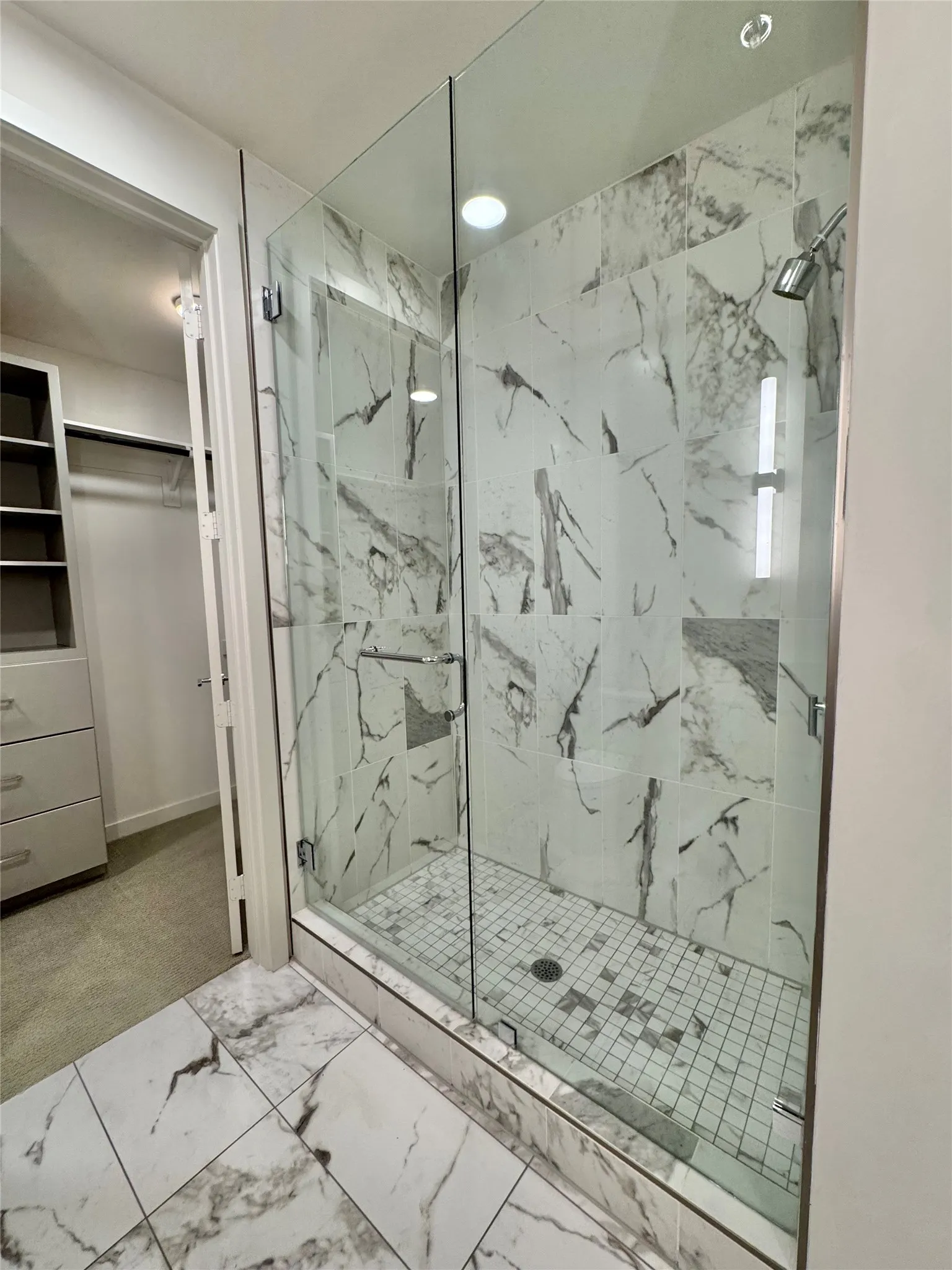 Bathroom featuring a shower with door