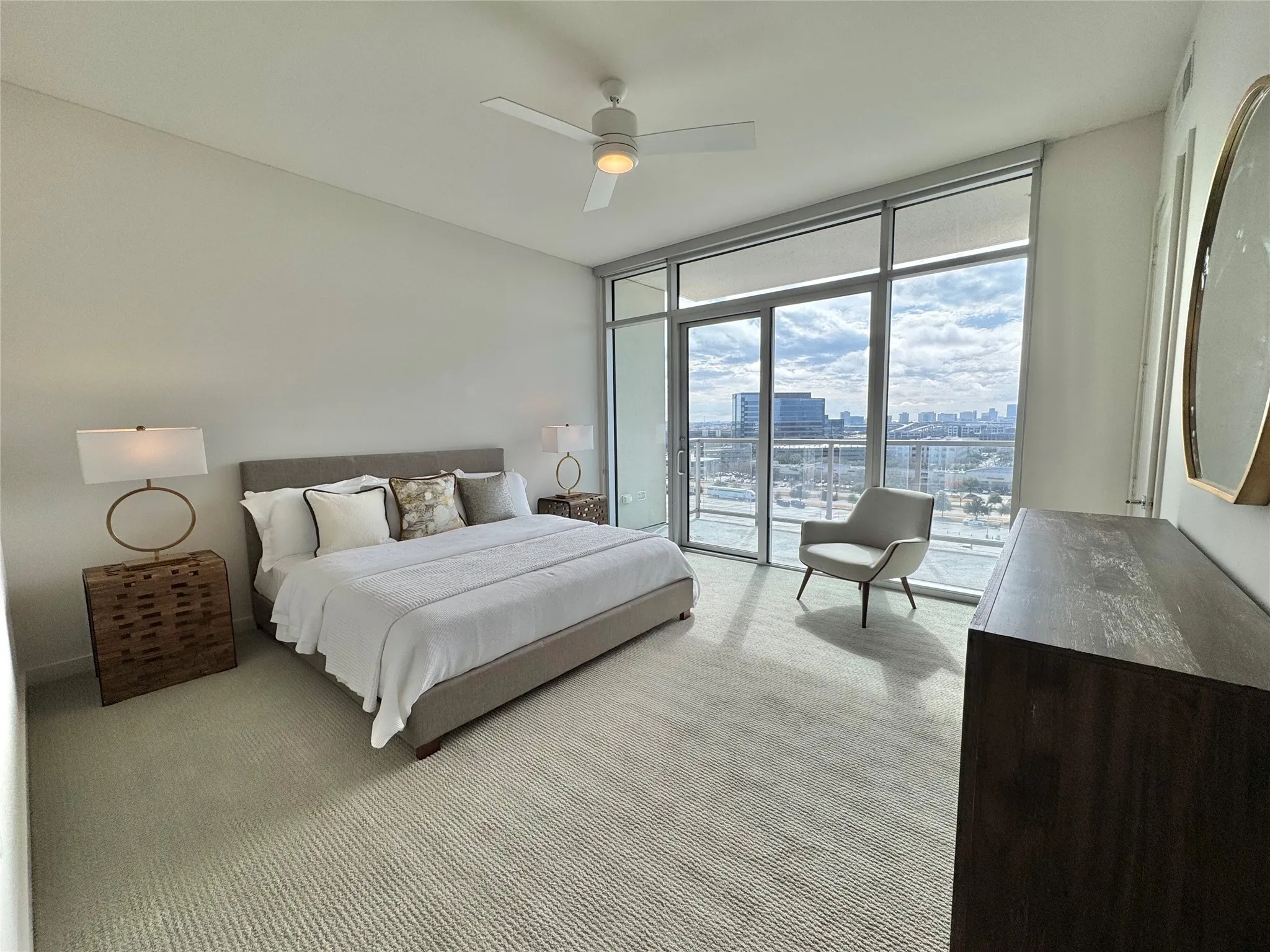 Bedroom with expansive windows, light colored carpet, access to exterior, and ceiling fan