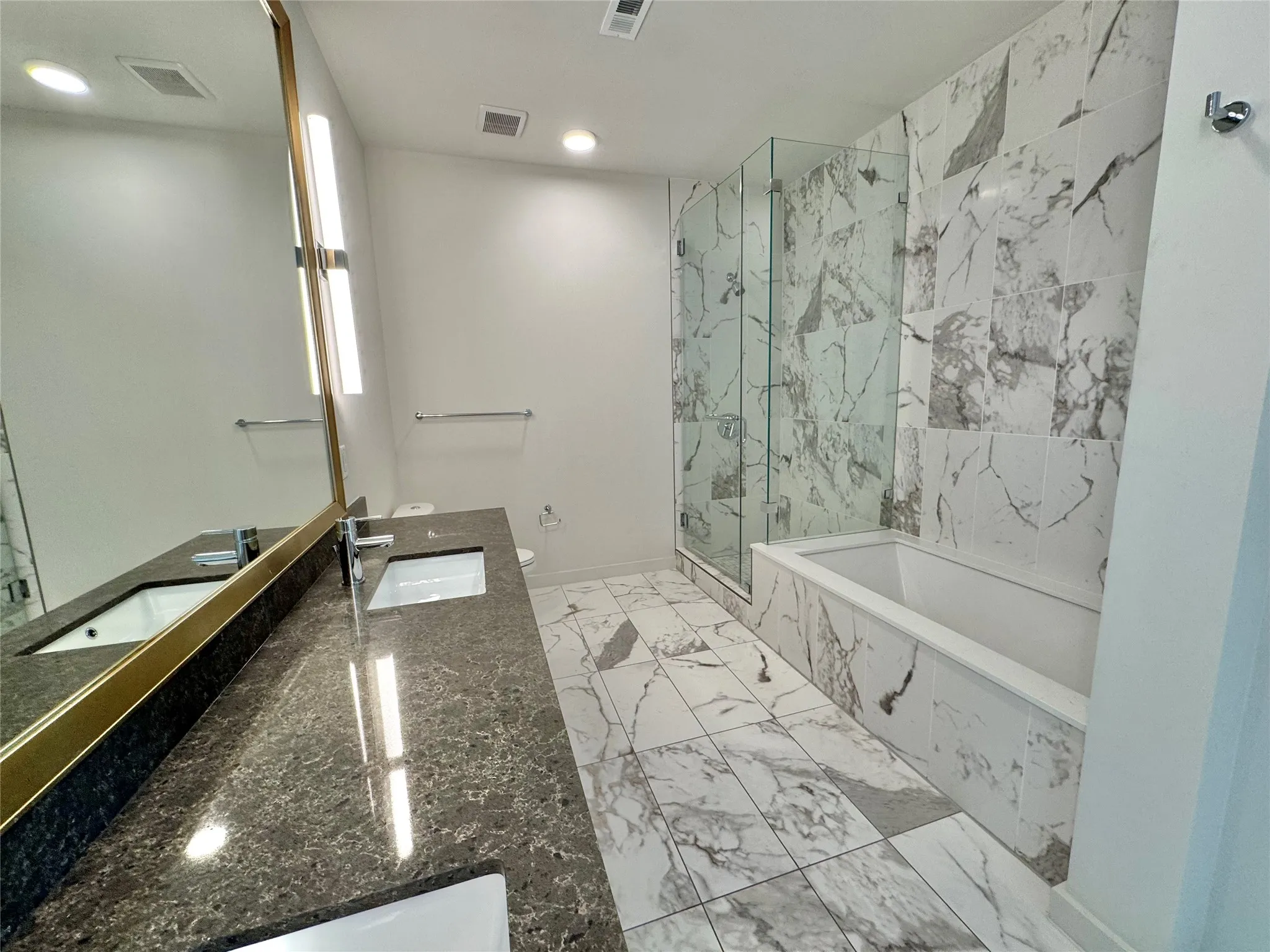 Full bathroom with vanity, shower with separate bathtub, and toilet