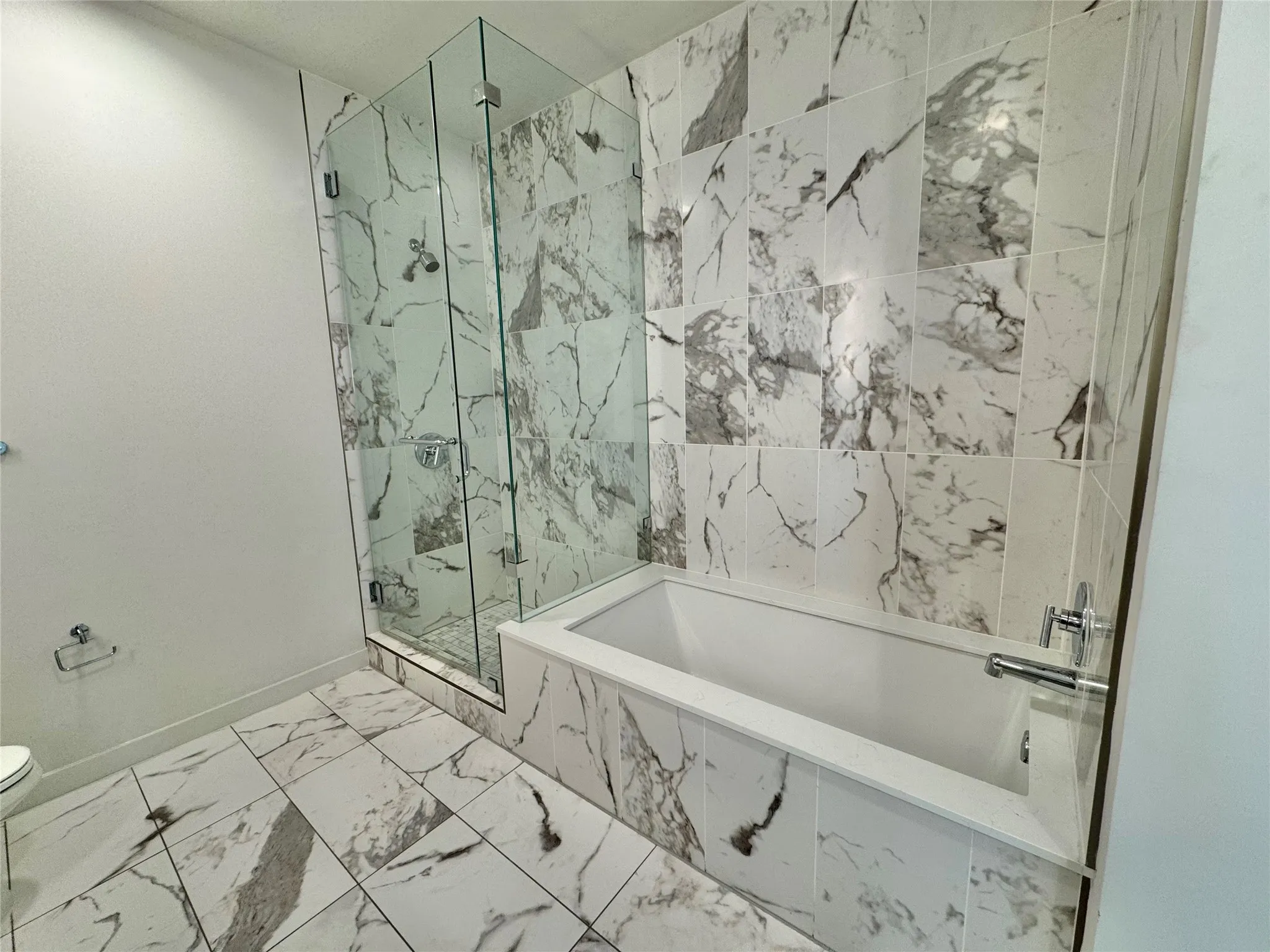 Bathroom featuring toilet and separate shower and tub