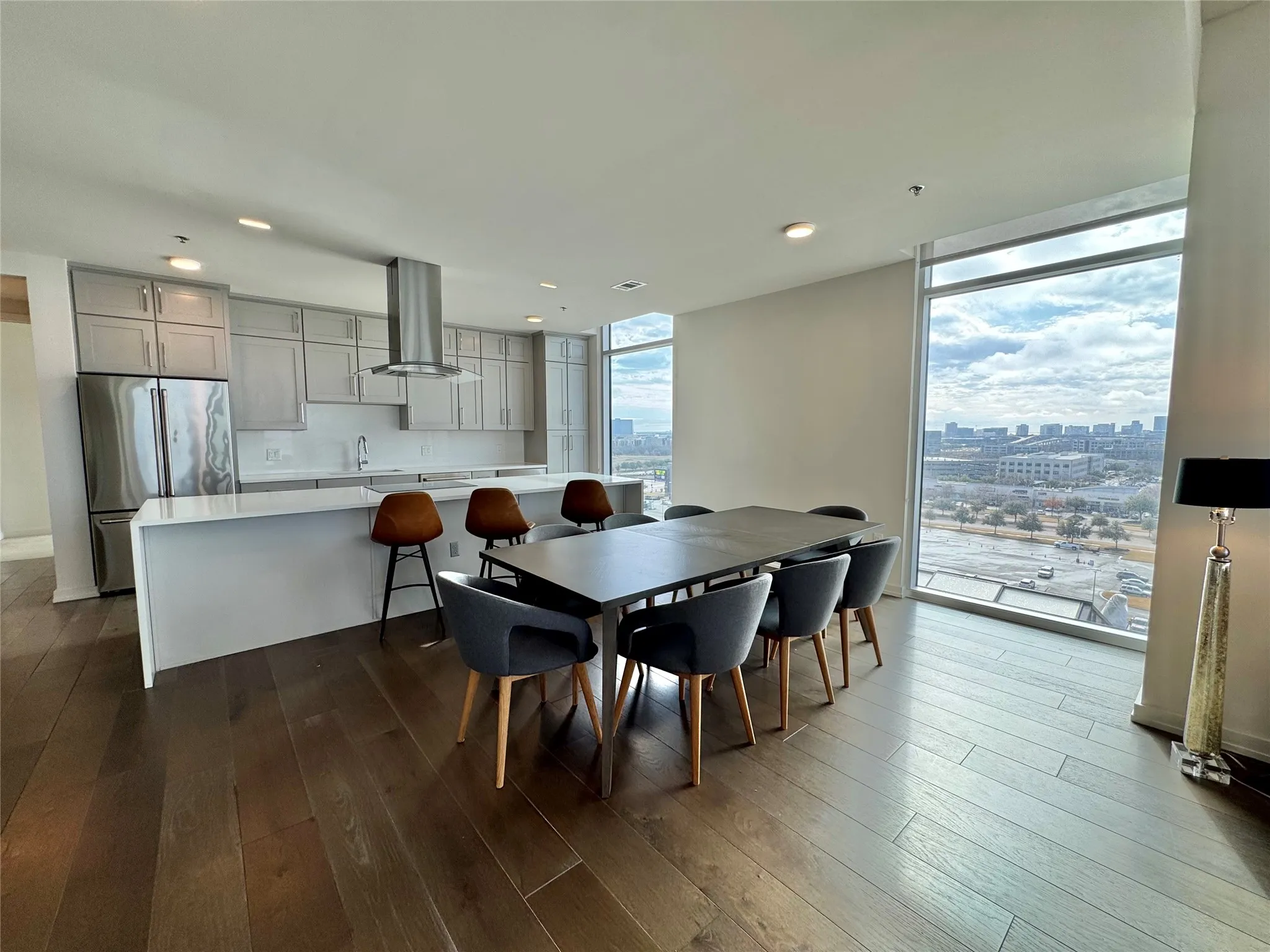 Dining space featuring wood-type flooring and a wall of windows