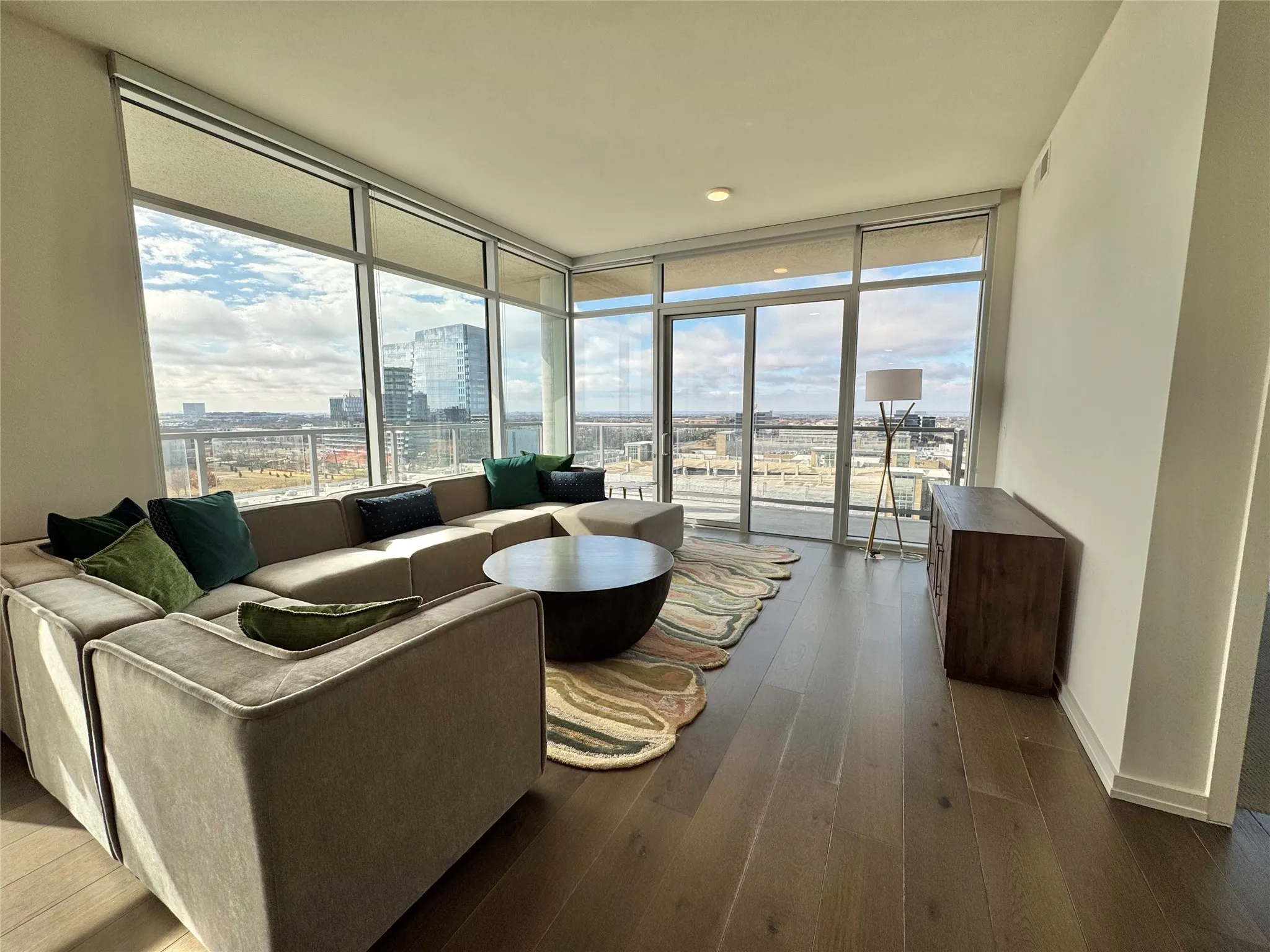 Living room featuring hardwood / wood-style flooring and expansive windows