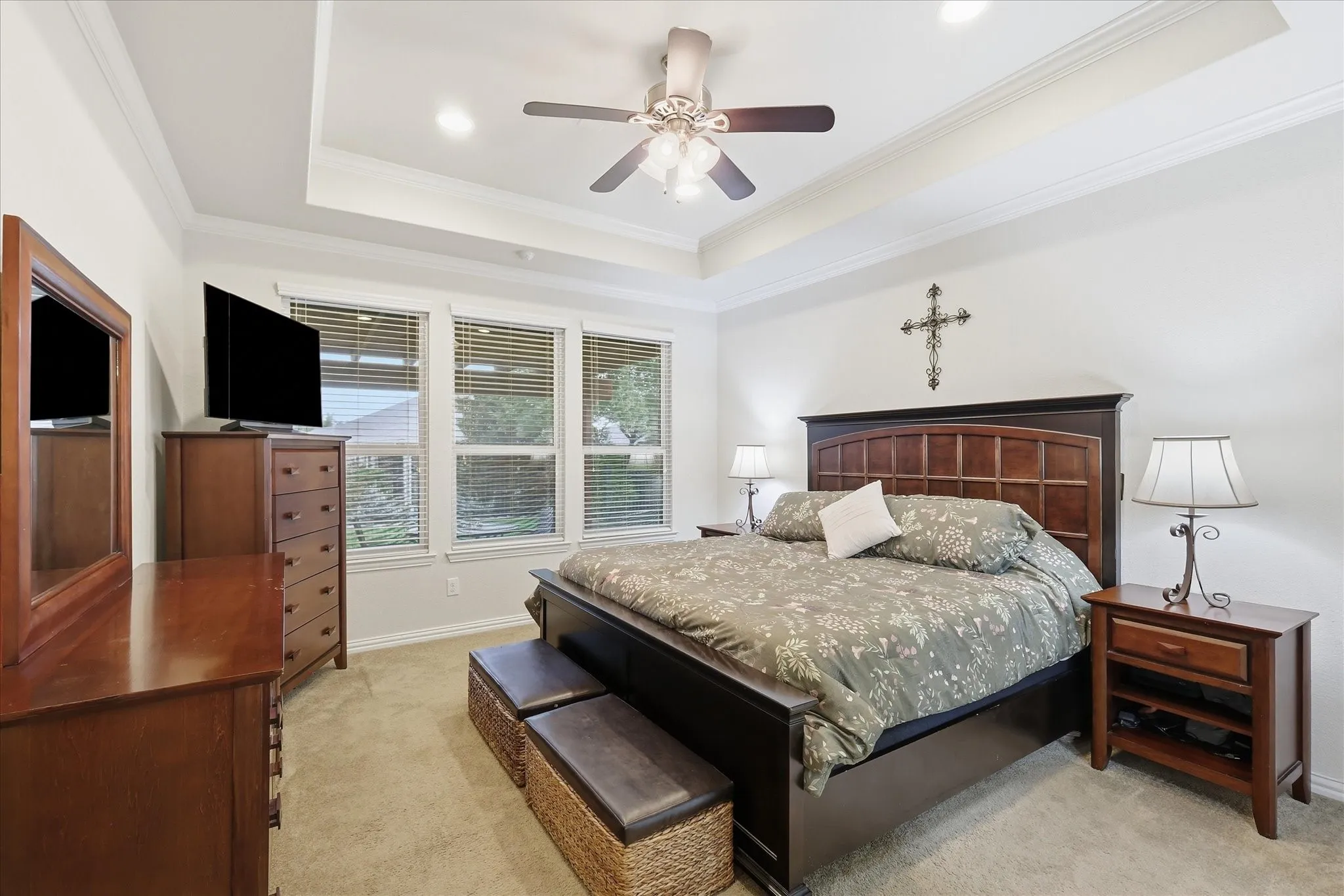 Primary Bedroom with tray ceiling, recessed lighting, central ceiling fan, and multi-pane windows