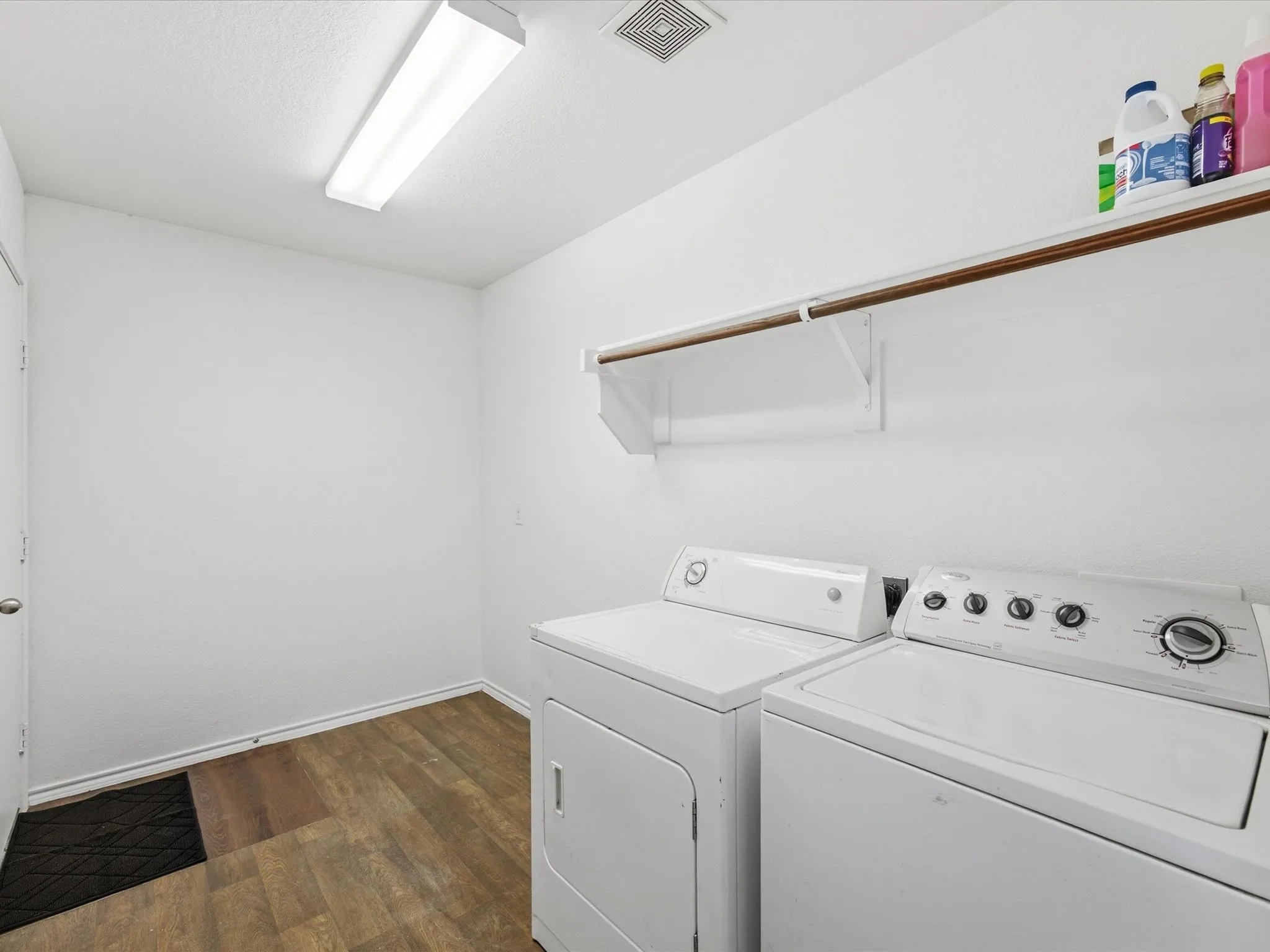 Great big laundry room with a clothes rod to hang your clothes