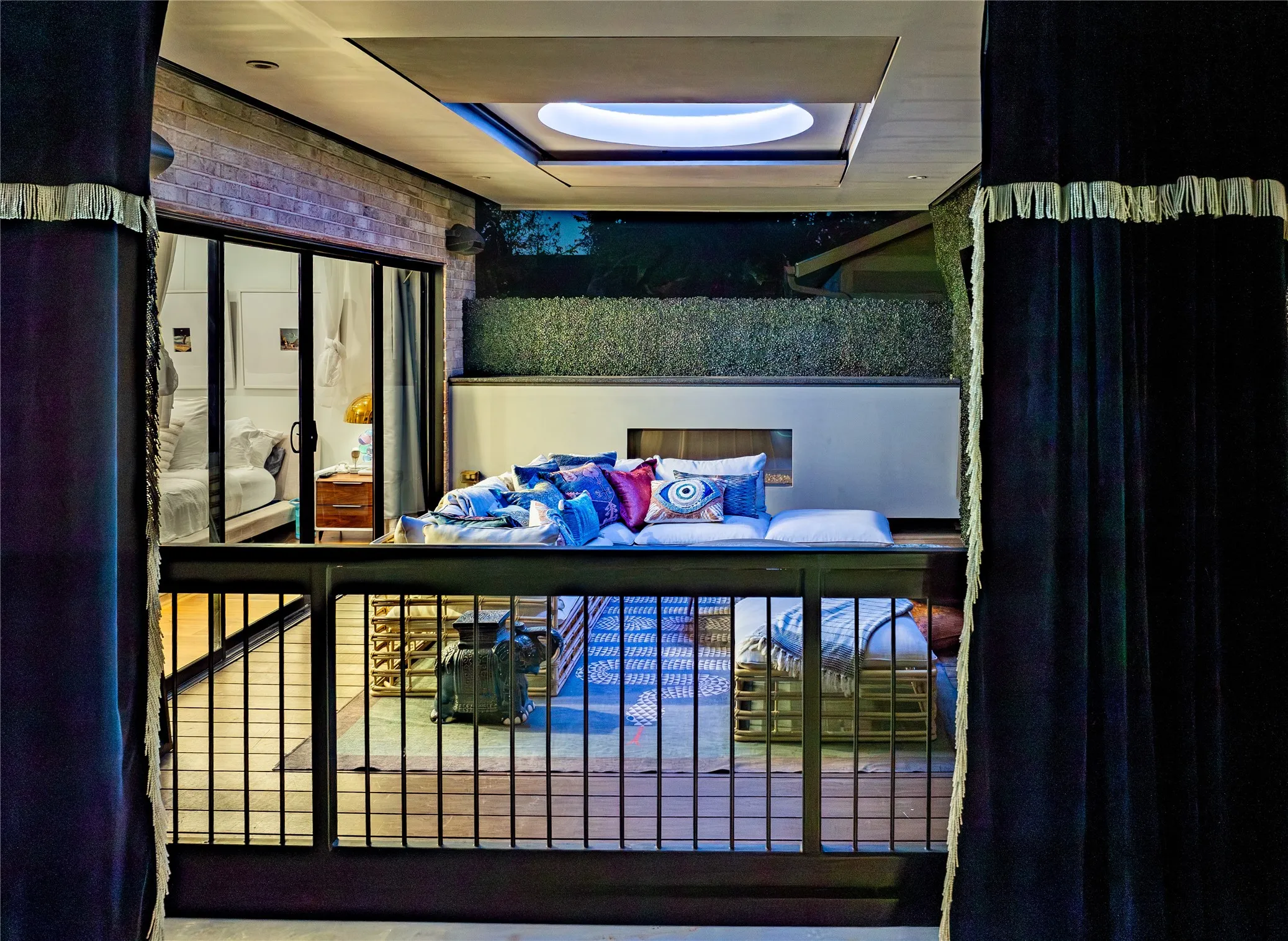Balcony off the primary suite with a circular skylight, a fireplace, and great views of the pool area and the sky.