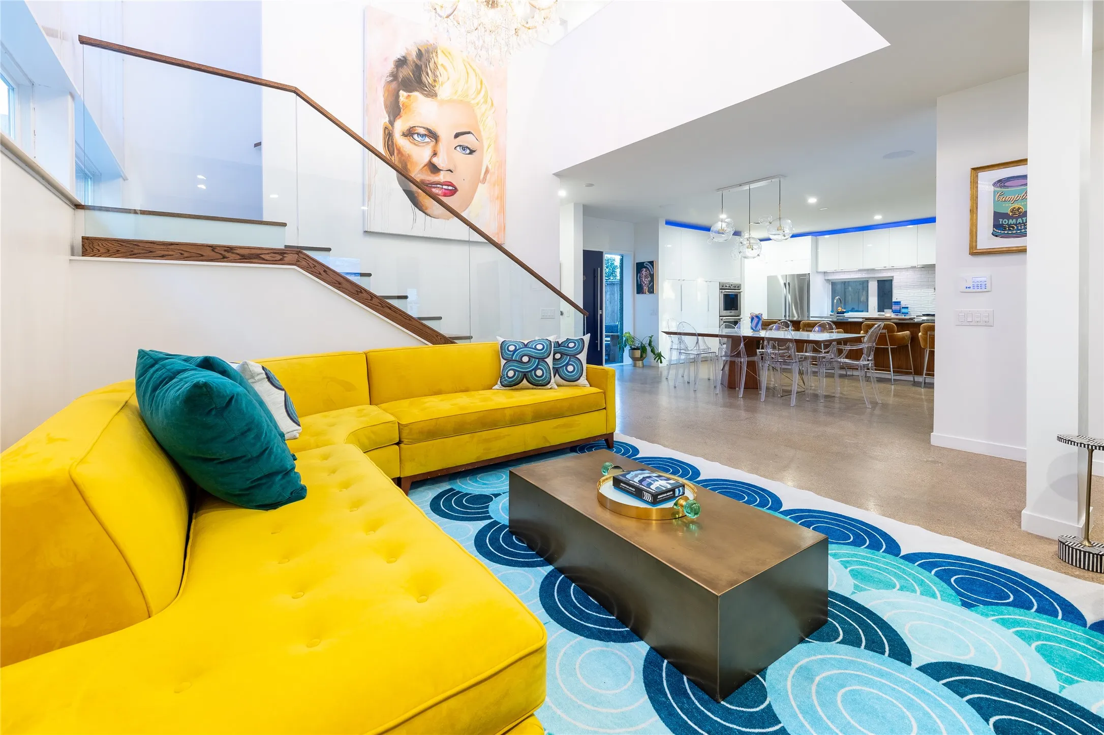The living area opens to a large kitchen and dining area.